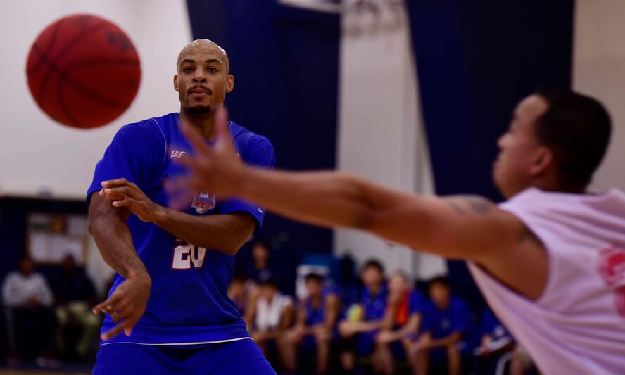 Nile Murry, Aomori Wats team member, passes a basketball to a teammate at Misawa Air Base, Japan, Sept. 6, 2015. This exhibition game was part of a series played to provide both teams with an advantage by scrimmaging before the upcoming season. (U.S. Air Force photo by Airman 1st Class Jordyn Fetter/Released)