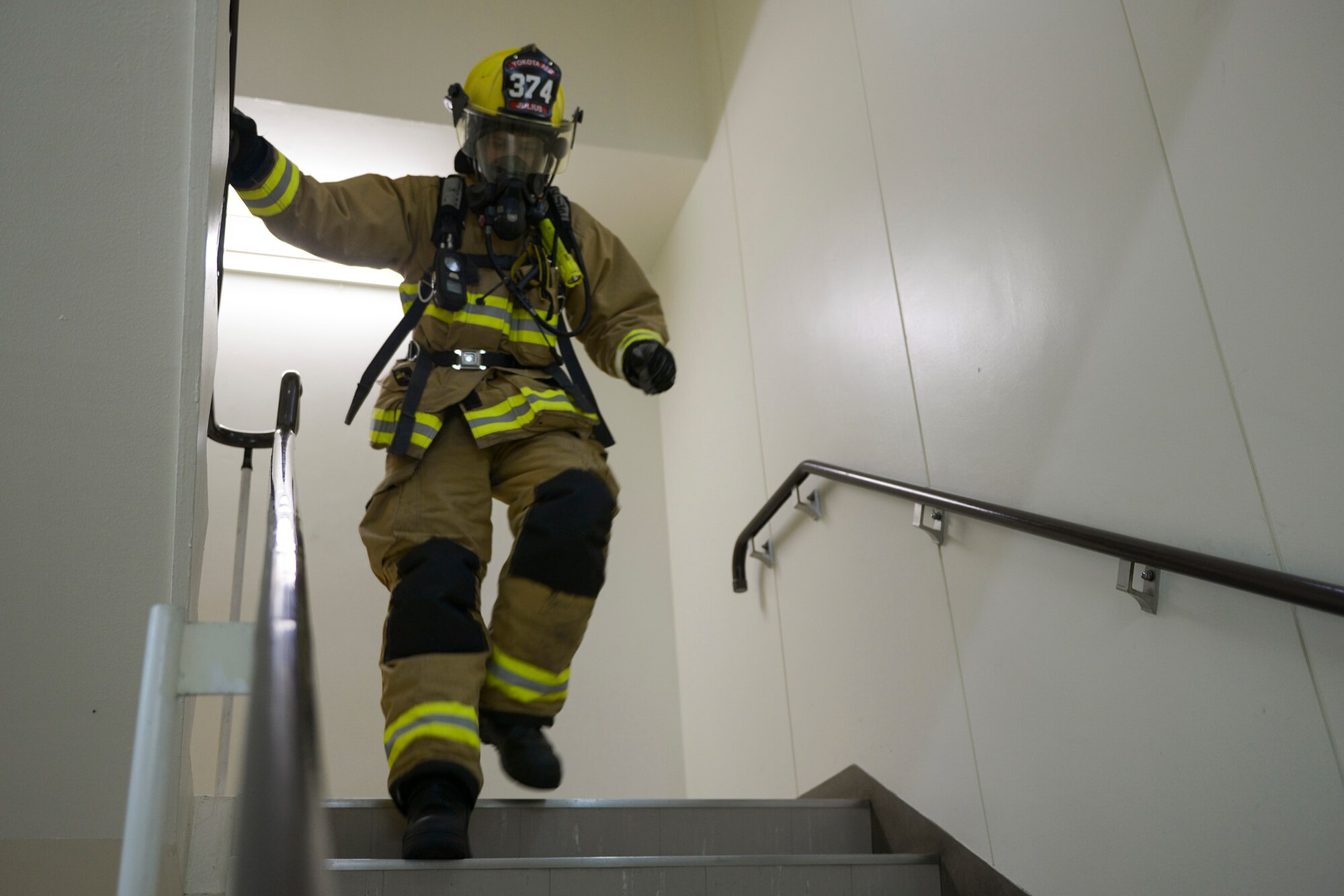 A 374th Civil Engineer Squadron fire protection member runs down a tower during the
Emergency Services 9/11 Tower Run at Yokota Air Base, Japan, Sept. 11, 2015. More
than 100 members throughout Yokota participated in the event, remembering the lives
lost during 9/11. (U.S. Air Force photo by Staff Sgt. Cody H. Ramirez/Released)