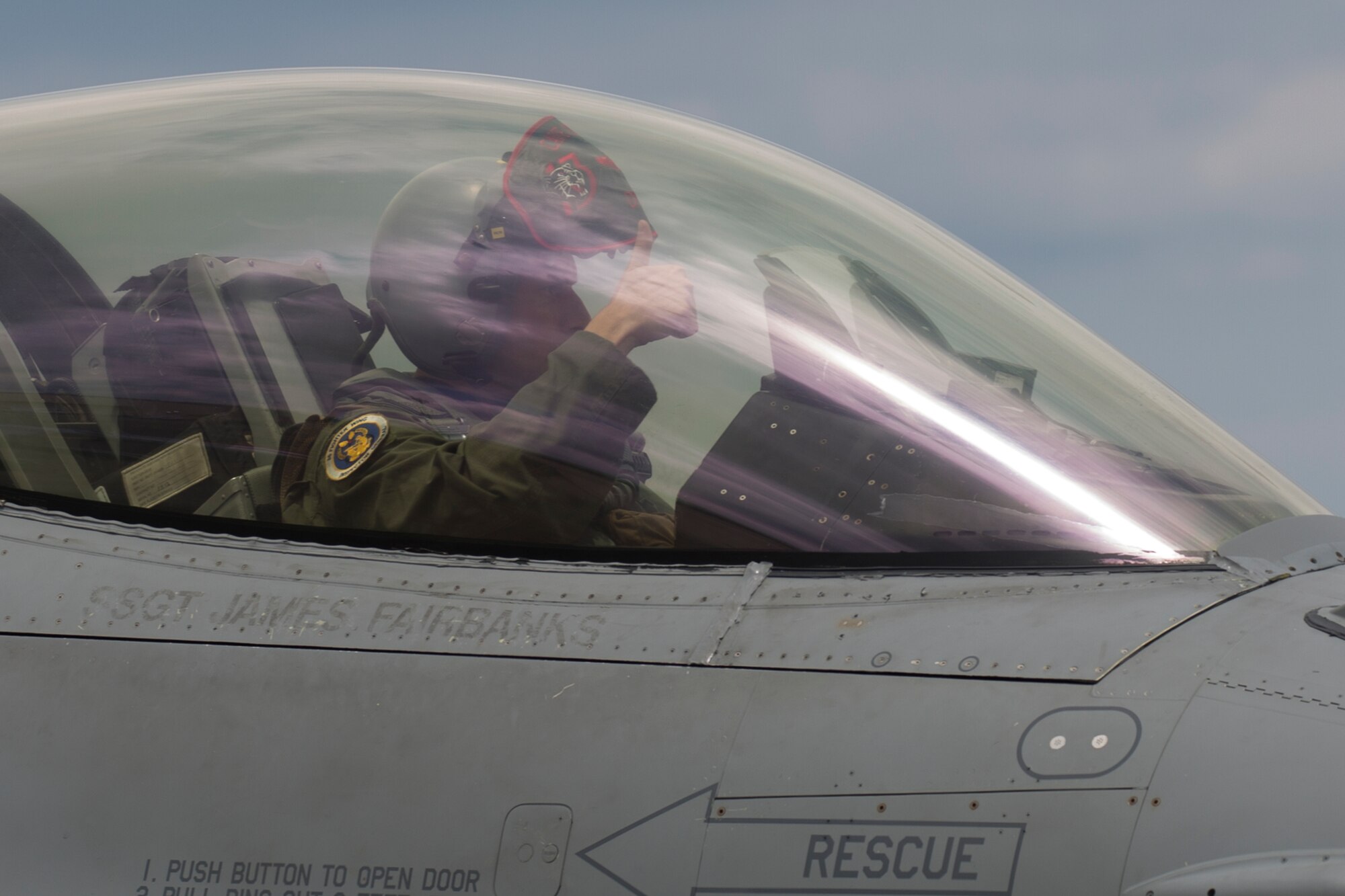 Lt. Col. Kevin Lord, 35th Fighter Wing inspector general, signals ready to a transient alert Airman at Yokota Air Base, Japan, July 24, 2015. Nineteen years ago, Lord took off from Yokota's runway in a Cessna-152 with aspirations to be a pilot in the United Sates Air Force. Now, in 2015, he is a lieutenant colonel and F-16 pilot. (U.S. Air Force photo by Osakabe Yasuo/Released)