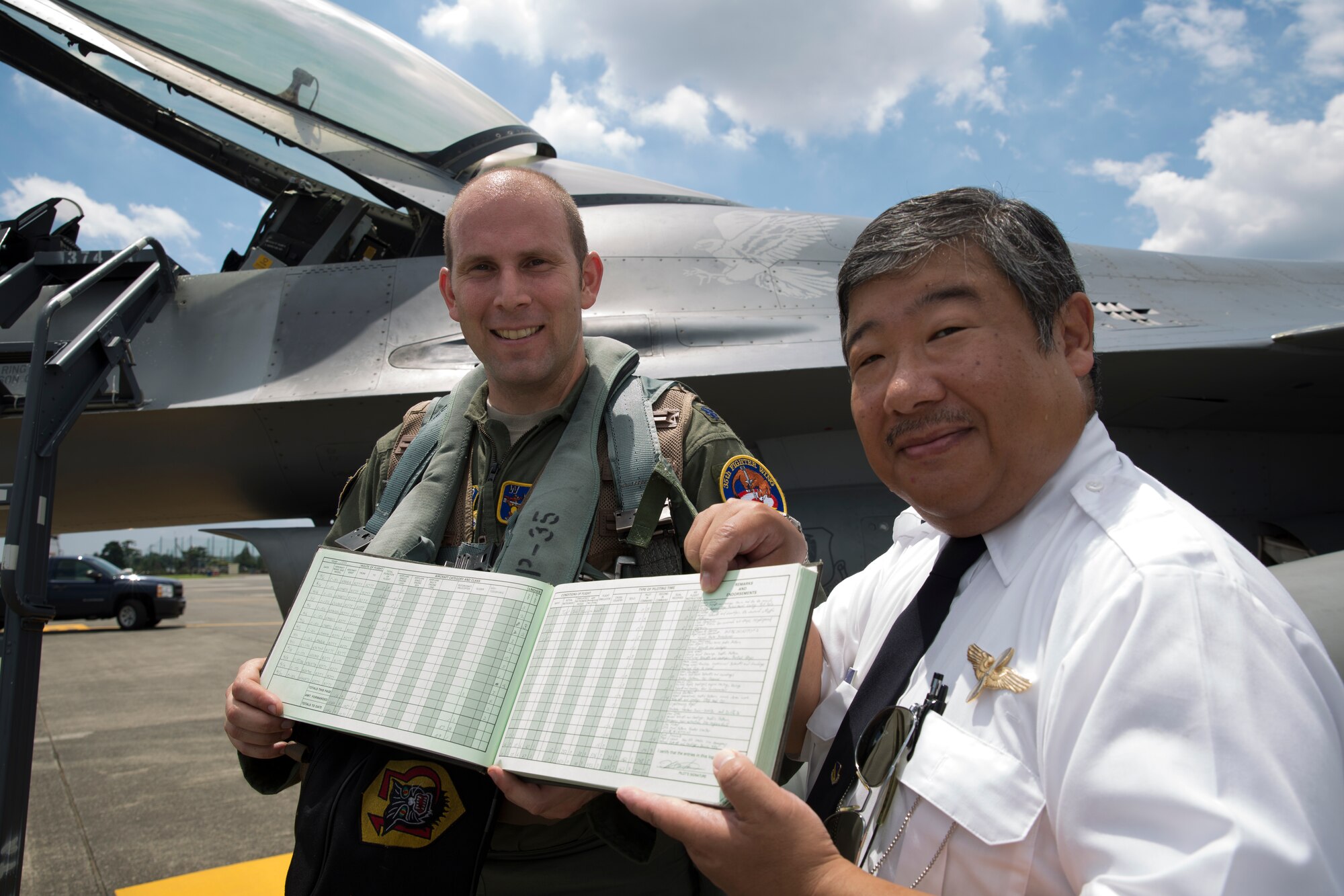 Lt. Col. Kevin Lord, 35th Fighting Wing inspector general, and Keita Nanko, 374th Operations Support Squadron air traffic specialist, hold a flight record from Lord's original flight training at Yokota Air Base, Japan, 24 July 2015. Nineteen years ago, Lord took off from Yokota's runway in a Cessna-152 with aspirations to be a pilot in the United Sates Air Force. Now, in 2015, he is a lieutenant colonel and F-16 pilot. (U.S. Air Force photo by Osakabe Yasuo/Released)
