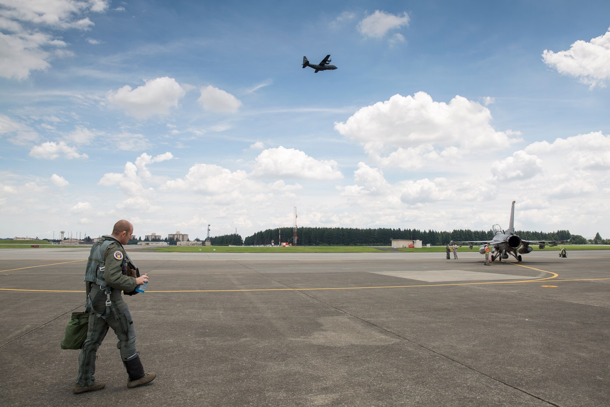 Lt. Col. Kevin Lord, 35th Fighting Wing inspector general, approaches an F-16 Fighting Falcon at Yokota Air Base, Japan, July 24, 2015. Lord spent his teenage years at Yokota and it was here he was inspired to join the United States Air Force. (U.S. Air Force photo by Osakabe Yasuo/Released)