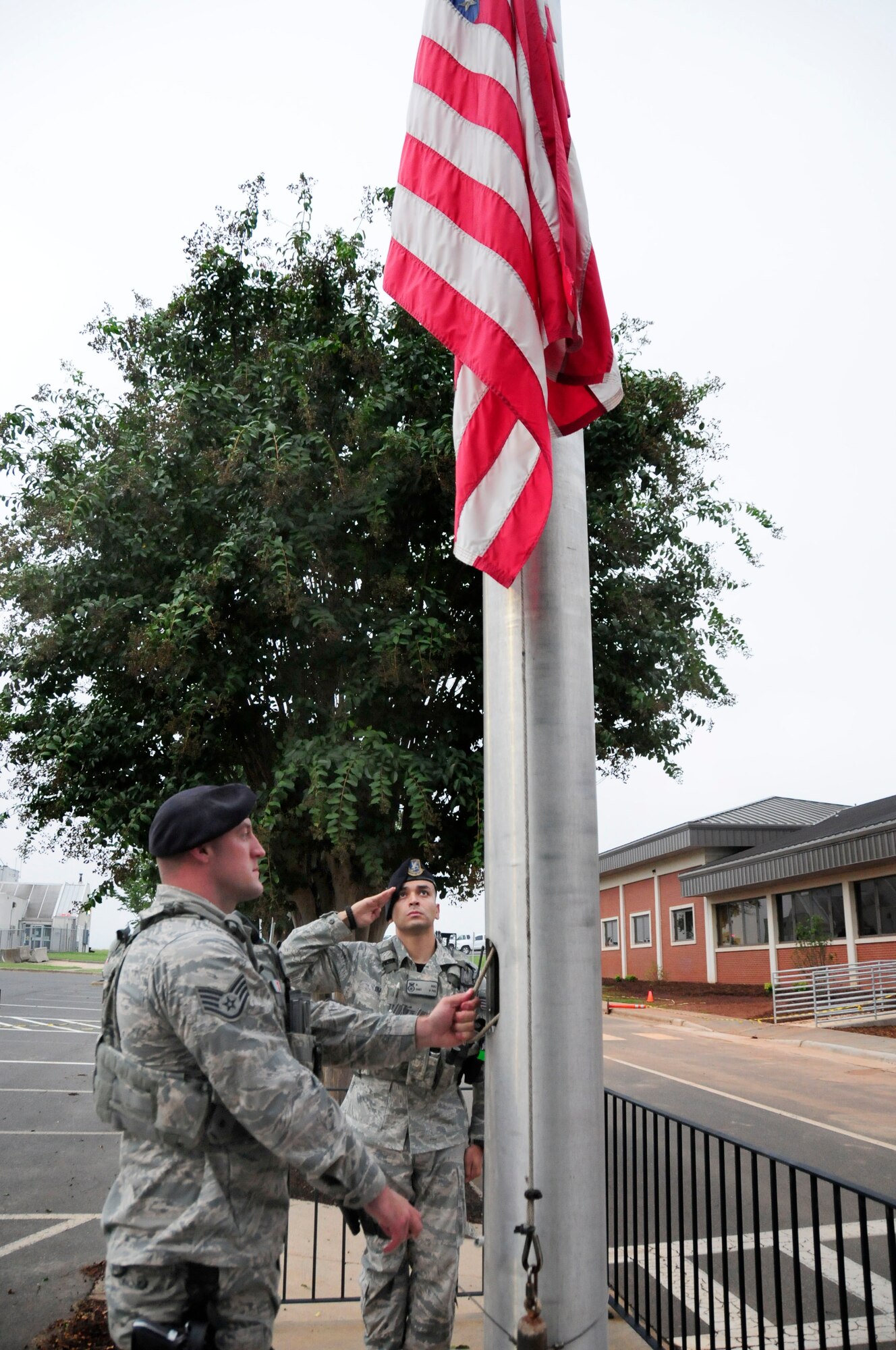 As directed by President Barack Obama, U.S. Air Force Staff Sgts. Blake Morgan and Norman Diaz, 145th Security Forces Squadron, lower the flag to half-staff at the North Carolina Air National Guard Base, Charlotte Douglas International Airport, Sept. 11, 2015. The flag will remain at half-staff until sunset in honor of those who lost their lives, 14 years ago today. (U.S. Air National Guard photo by Master Sgt. Patricia F. Moran, 145th Public Affairs/Released)
