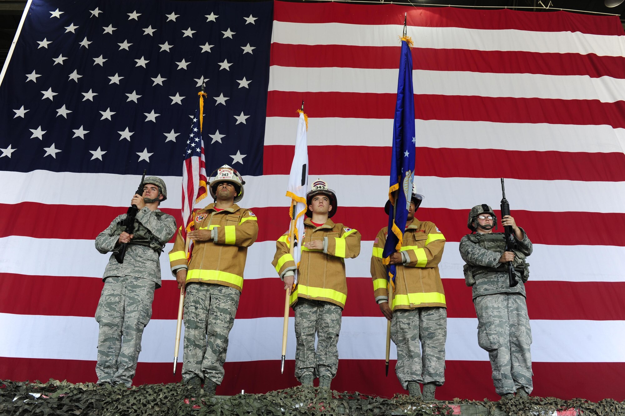 Airmen from the 8th Fighter Wing prepare to post the colors during a 9-11 Remembrance Day Ceremony at Kunsan Air Base, Republic of Korea, Sept. 11, 2015. United States Air Force Airmen and Republic of Korea air force members attended the ceremony to the remember the events that occurred during the terrorist attacks14 years ago. (U.S. Air Force photo by Staff Sgt. Nick Wilson/Released)