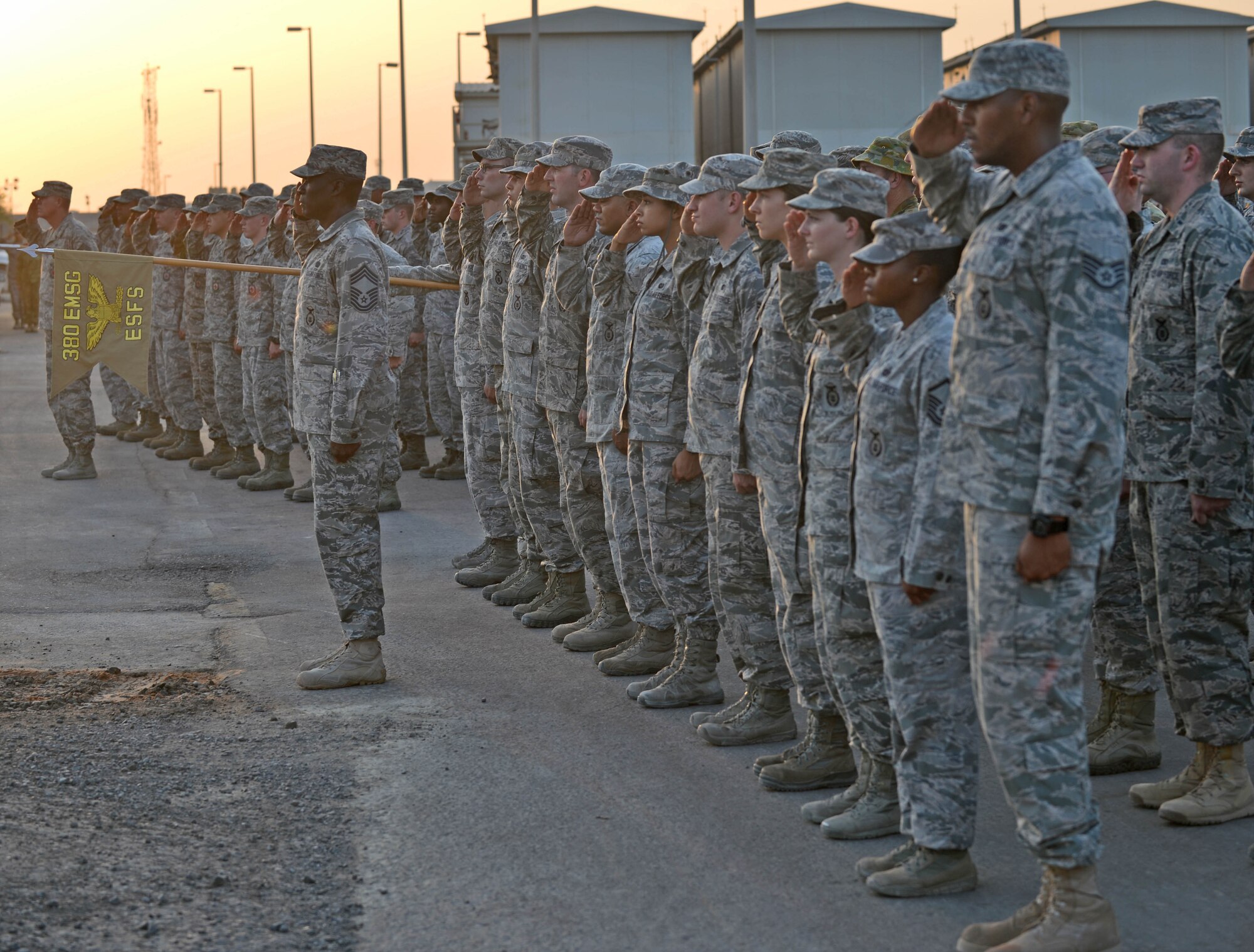 Airmen from the 380th Air Expeditionary Wing salute during a 9/11 Retreat ceremony at an undisclosed location in Southwest Asia Sept. 11, 2015. The ceremony was held in honor of the 2,977 lives lost from the 9/11 attacks. (U.S. Air Force Photo/Tech. Sgt. Jeff Andrejcik) 