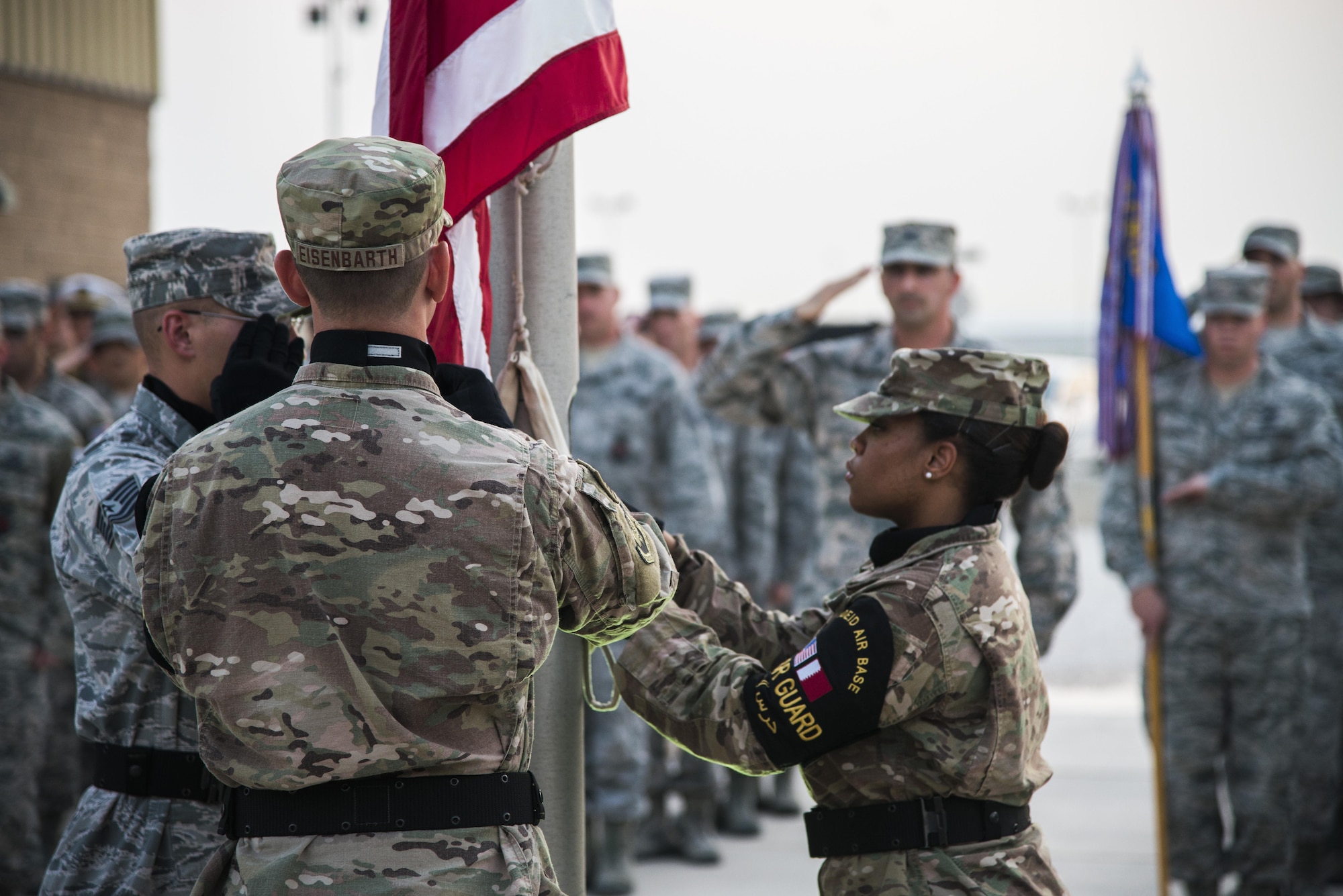 U.S. Air Force Airmen lower an American flag during a retreat ceremony recognizing the fourteenth anniversary of Sept. 11, 2001, at Al Udeid Air Base, Qatar, Sept. 11, 2015. The retreat ceremony signals the end of the official duty day and serves as a ceremony for paying respect to the flag. In this ceremony, respect was paid to the flag and the memory of those lost on Sept. 11, 2001. (U.S. Air Force photo/Tech. Sgt. Rasheen Douglas)