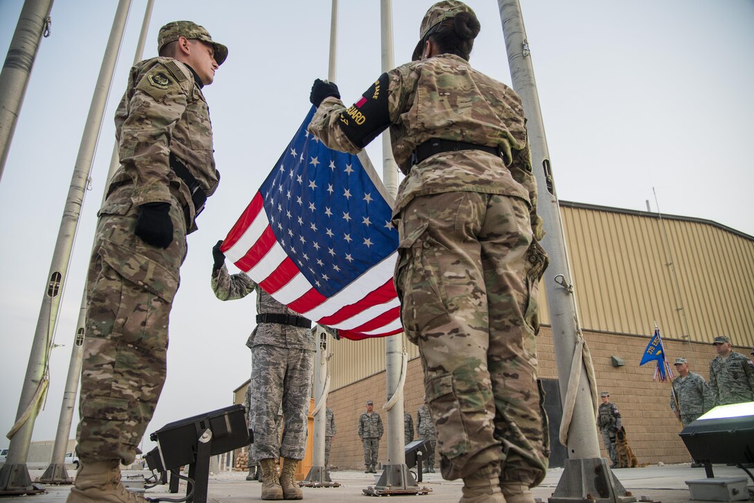 U.S. Air Force Airmen begin to fold an American flag during a
retreat ceremony recognizing the fourteenth anniversary of Sept. 11, 2001, at Al Udeid Air Base, Qatar, Sept. 11, 2015. The retreat ceremony signals the end of the official duty day and serves as a ceremony for paying respect to the flag. In this ceremony, respect was paid to the flag and the memory
of those lost on Sept. 11, 2001. (U.S. Air Force photo/Tech. Sgt. Rasheen Douglas)

