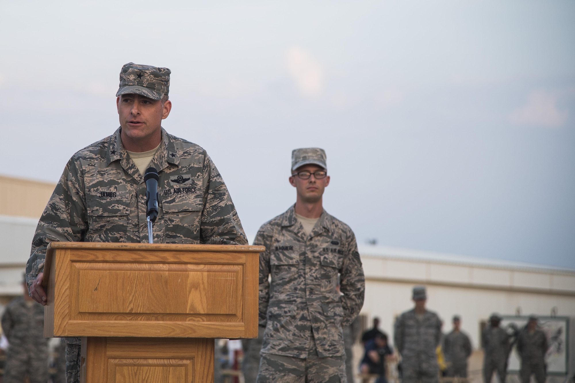 Brig. Gen. Darren James, 379th Air Expeditionary Wing commander, speaks to Airmen and coalition forces at the beginning of a retreat ceremony recognizing the fourteenth anniversary of Sept. 11, 2001, at Al Udeid Air Base, Qatar, Sept. 11, 2015. The retreat ceremony signals the end of the official duty day and serves as a ceremony for paying respect to the flag. In this ceremony, respect was paid to the flag and the memory of those lost on Sept. 11, 2001. (U.S. Air Force photo/Tech. Sgt. Rasheen Douglas) 