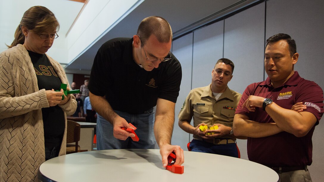 A team completes a leadership exercise during a Marine Corps Leadership Seminar at Arizona State University at Tempe, Arizona, Sept. 11, 2015. The seminar was an event supporting Marine Week Phoenix, which aims to connect the Corps with the people of Arizona.