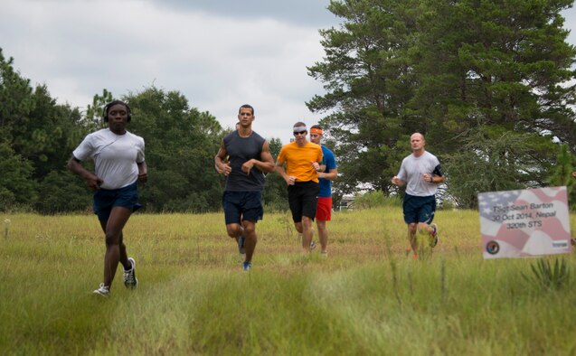 Members of the 919th Special Operations Wing run during the “Never Forget” trail run at Duke Field, Fla., Sept. 12. The run honored those members of Air Force Special Operations Command who fell in service since 9/11. More than 45 Airmen ran past signs with names, dates and locations of the 61 deceased Airmen throughout the three-mile trail. (U.S. Air Force photo/Tech. Sgt. Jasmin Taylor)