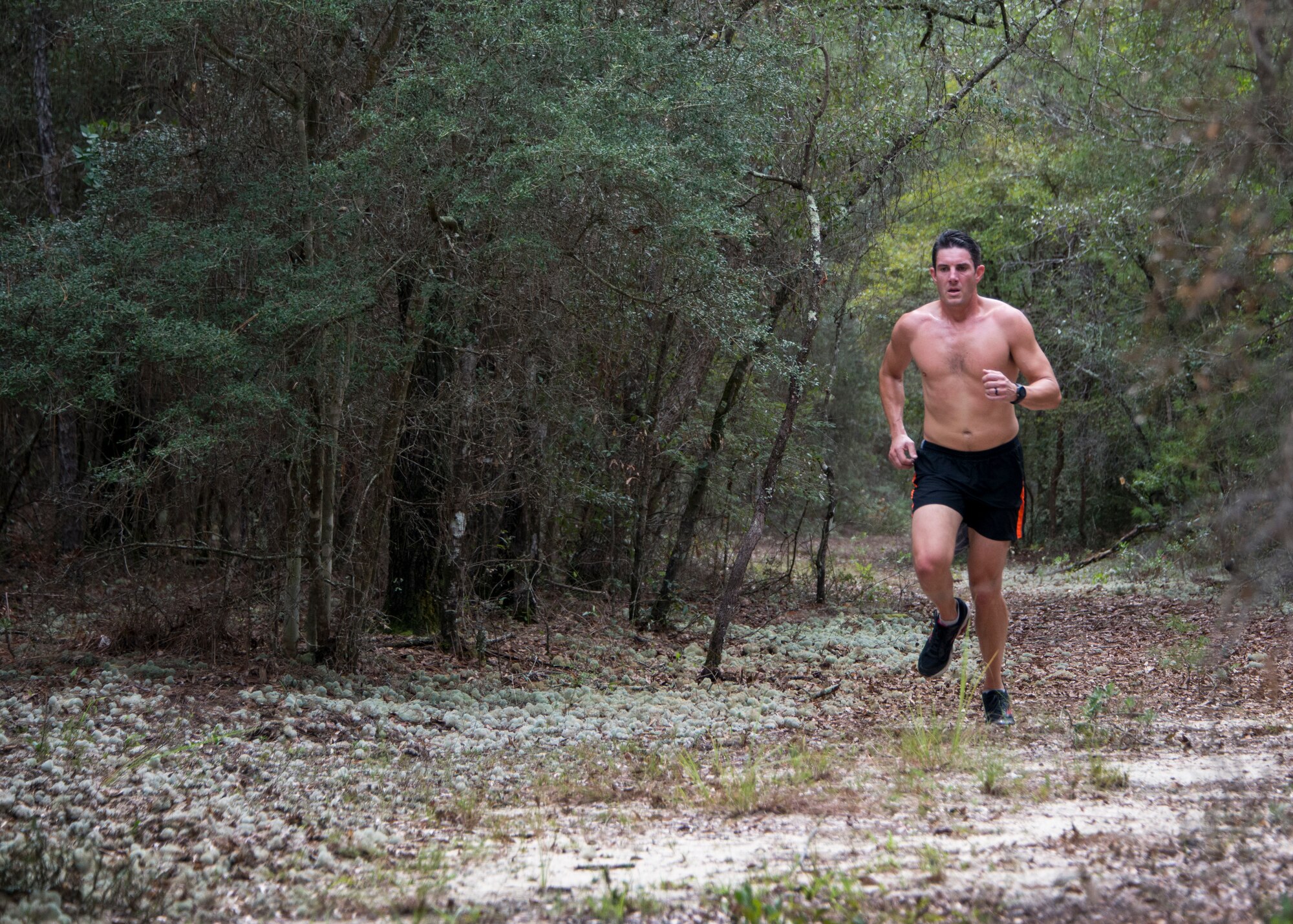 Maj. Austin White, 5th Special Operations Squadron, runs during the “Never Forget” trail run at Duke Field, Fla., Sept. 12. The run honored those members of Air Force Special Operations Command who fell in service since 9/11. More than 45 Airmen ran past signs with names, dates and locations of the 61 deceased Airmen throughout the three-mile trail. (U.S. Air Force photo/Tech. Sgt. Jasmin Taylor)
