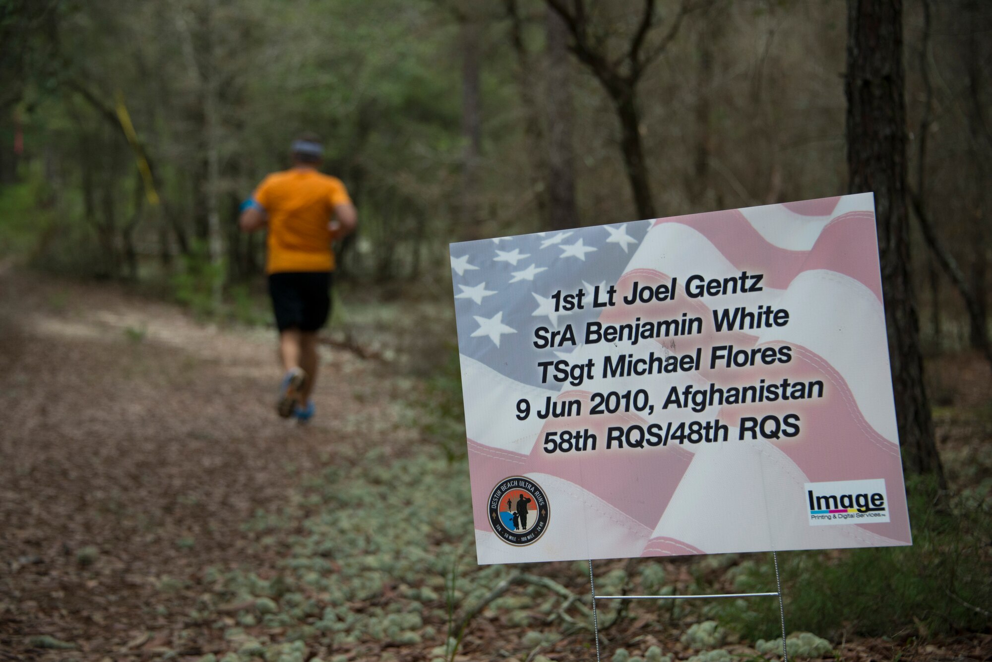 A 919th Special Operations Wing Airman jogs during the “Never Forget” trail run at Duke Field, Fla., Sept. 12. The run honored those members of Air Force Special Operations Command who fell in service since 9/11. More than 45 Airmen ran past signs with names, dates and locations of the 61 deceased Airmen throughout the three-mile trail. (U.S. Air Force photo/Tech. Sgt. Jasmin Taylor)