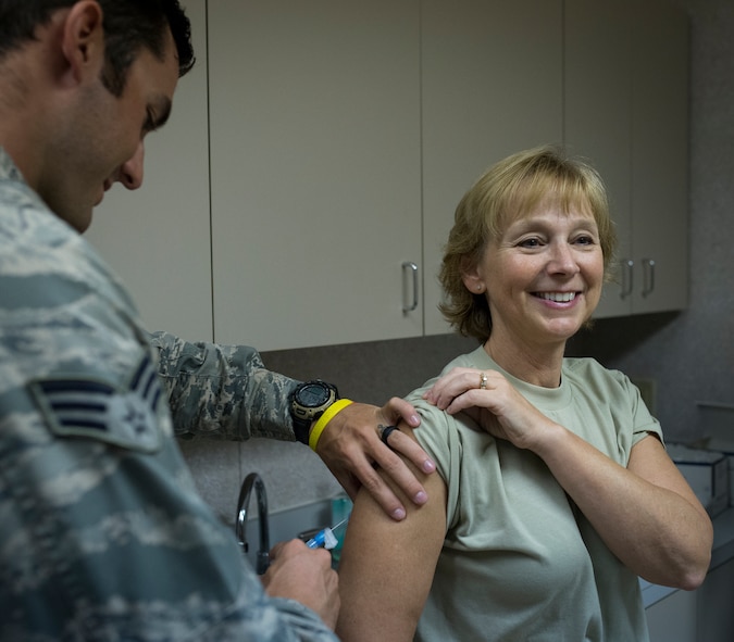 Senior Airman Michael Honeywell, 919th Special Operations Medical Squadron, injects Chief Master Sgt. Karilyn Graham, 919th Special Operations Force Support Squadron, with the flu vaccine at Duke Field Fla., Sept. 12. The flu vaccine is an annual requirement for all members of the 919th Special Operations Wing. (U.S. Air Force photo/Tech. Sgt. Jasmin Taylor) 