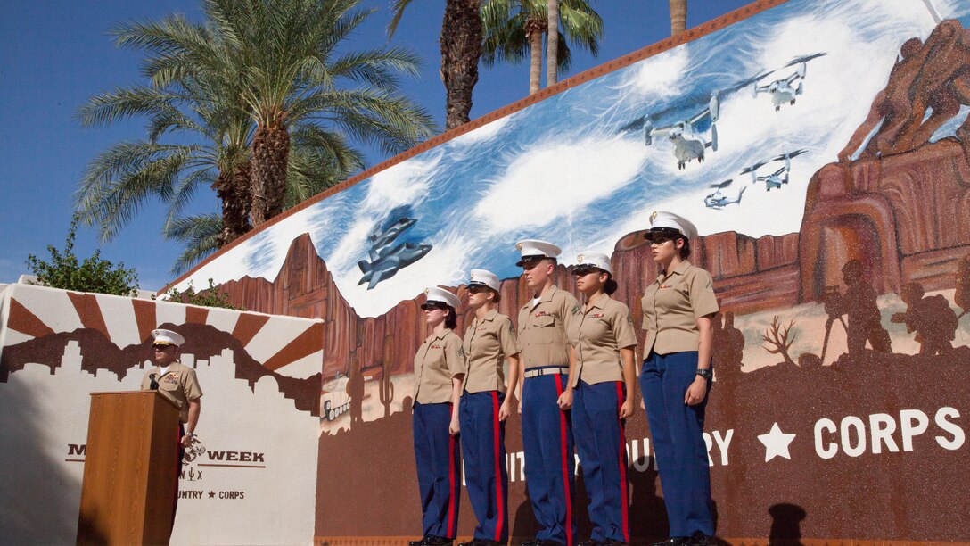 Five Marine artists are recognized during the unveiling of the Marine Week Phoenix mural in Scottsdale, Ariz., Sept. 12, 2015. They worked for nearly a week in temperatures upwards of 100 degrees to finish the mural celebrating relationships built during the week between the Corps and the people of Arizona.