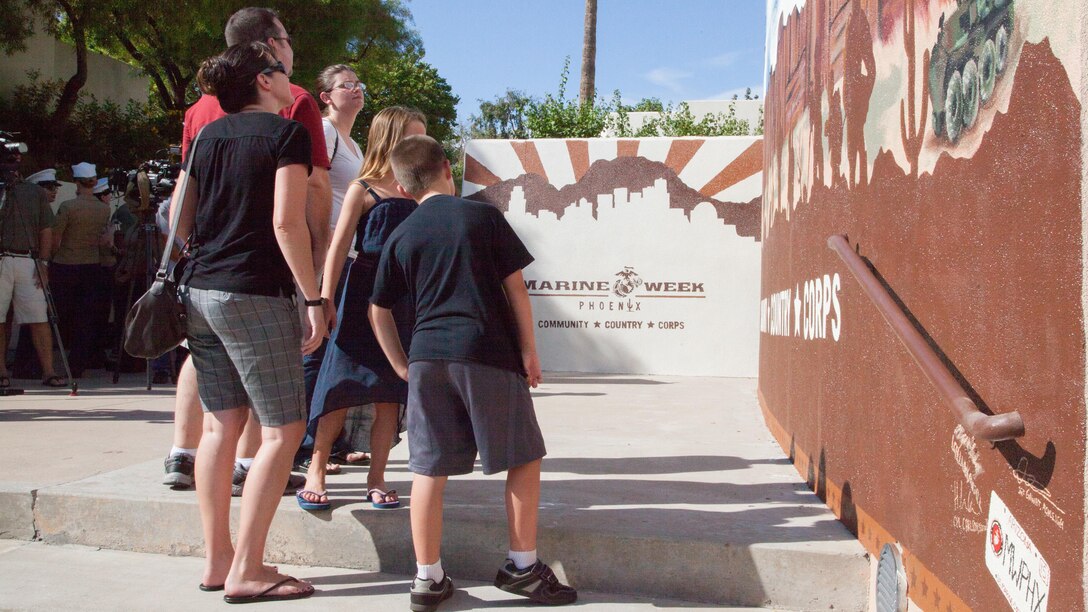 Lance Cpl. Jacob Hug’s family observes the memorial to him during the unveiling of the Marine Week Phoenix mural in Scottsdale, Ariz., Sept. 12, 2015. Hug and seven other Marines perished in a helicopter crash while the Corps was providing humanitarian assistance and disaster relief to Nepal. 
