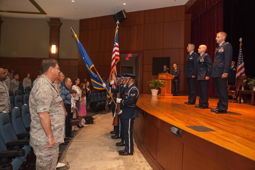 Members of the 315th Airlift Wing stand at attention during the National Anthem at a change of command ceremony today in the base theatre here. The 315th Aircraft Maintenance Squadron held its change of command ceremony today in the theatre. (U.S. Air Force photo by 2nd Lt. Rashard Coaxum)
