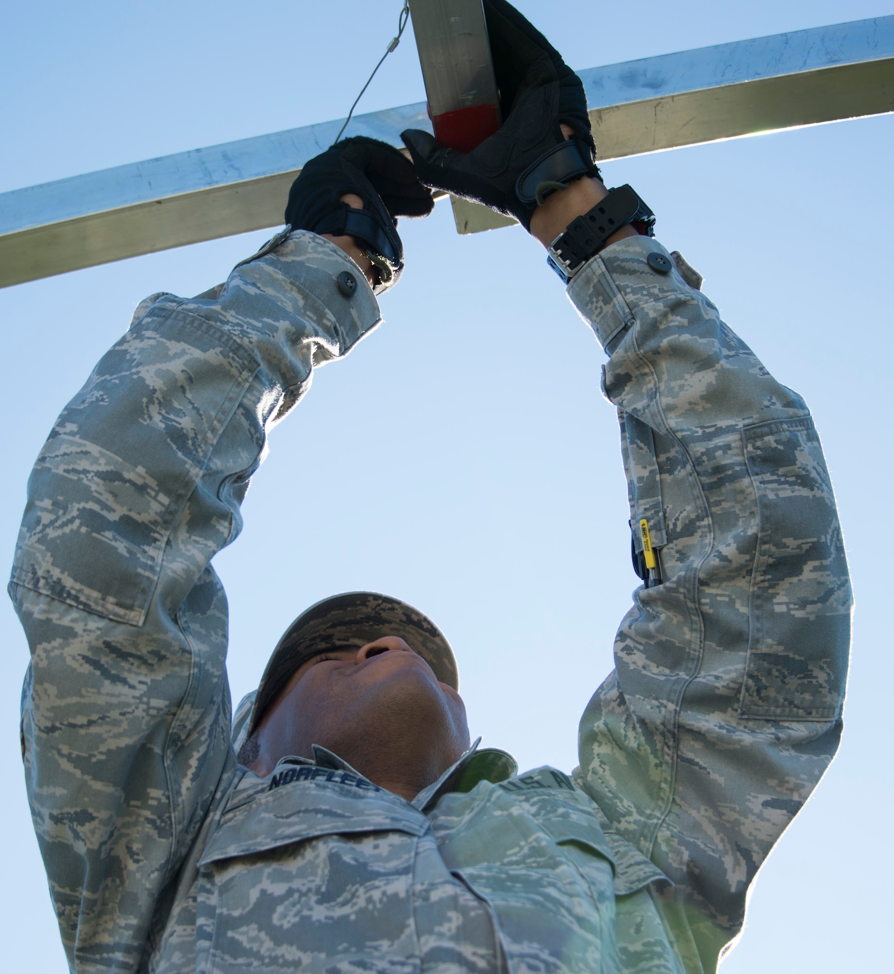 Senior Airman Edward Norfleet, 919th Special Operations Force Support Squadron, inserts a pin to hold a beam in place during small shelter system training at Duke Field, Fla., Sept. 13. The shelter takes six fully trained personnel approximately three and a half hours to complete. The SSS training is part of annual home station readiness training for all members of the squadron. (U.S. Air Force photo/ Tech. Sgt. Jasmin Taylor)  