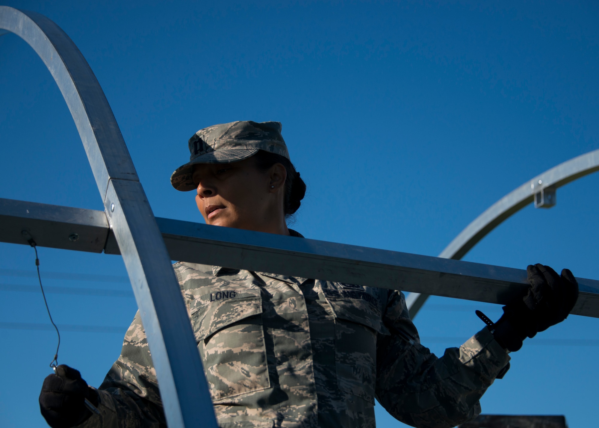 Capt. Sonya Long, 919th Special Operations Force Support Squadron, holds a beam in place during small shelter system training at Duke Field, Fla., Sept. 13. The shelter takes six fully trained personnel approximately three and a half hours to complete. The SSS training is part of annual home station readiness training for all members of the squadron. (U.S. Air Force photo/ Tech. Sgt. Jasmin Taylor)  
