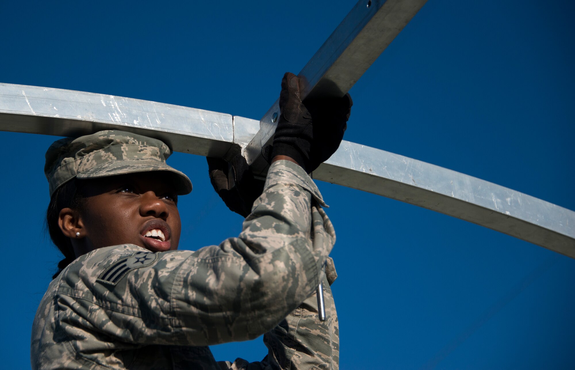 Senior Airman Charelle Baxter, 919th Special Operations Force Support Squadron, inserts a beam during small shelter system training at Duke Field, Fla., Sept. 13. The shelter takes six fully trained personnel approximately three and a half hours to complete. The SSS training is part of annual home station readiness training for all members of the squadron. (U.S. Air Force photo/ Tech. Sgt. Jasmin Taylor)  