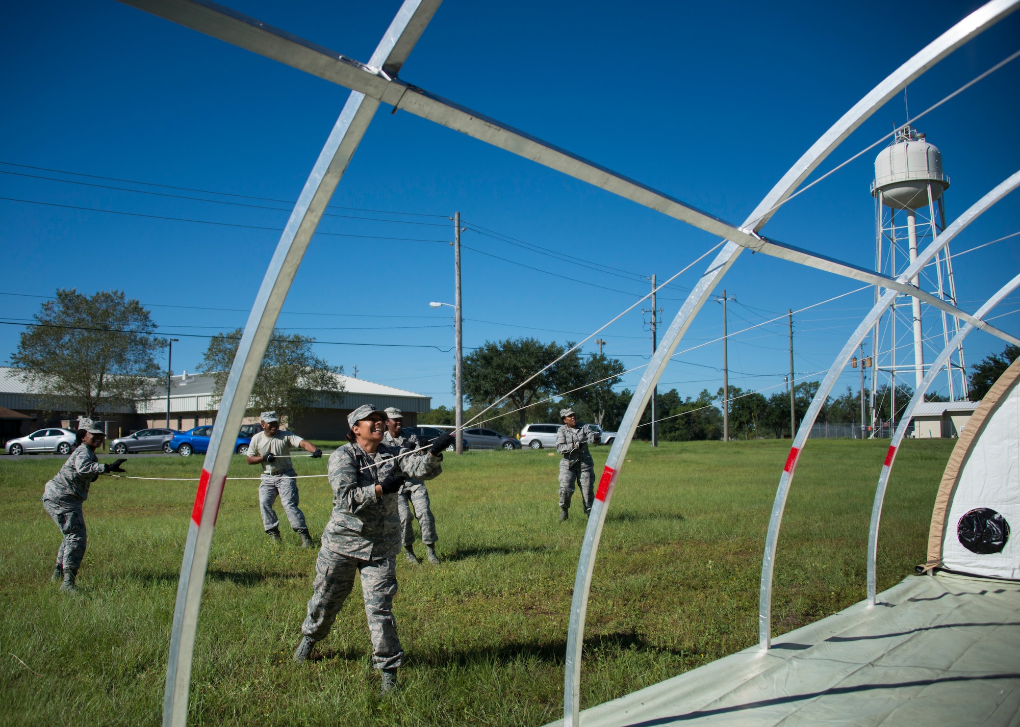 Members of the 919th Special Operations Force Support Squadron pull the canopy over the frame during small shelter system training at Duke Field, Fla., Sept. 13. The shelter takes six fully trained personnel approximately three and a half hours to complete. The SSS training is part of annual home station readiness training for all members of the squadron. (U.S. Air Force photo/ Tech. Sgt. Jasmin Taylor)  