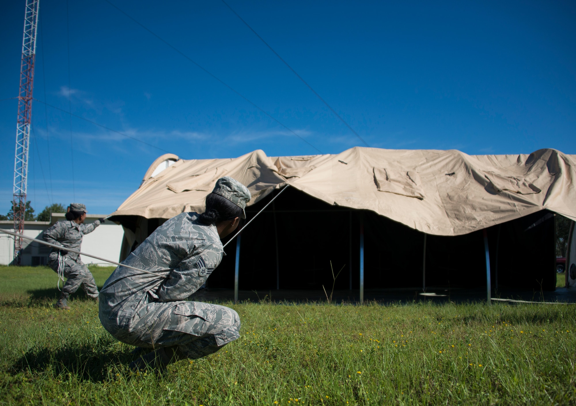 Members of the 919th Special Operations Force Support Squadron pull the canopy over the frame during small shelter system training at Duke Field, Fla., Sept. 13. The shelter takes six fully trained personnel approximately three and a half hours to complete. The SSS training is part of annual home station readiness training for all members of the squadron. (U.S. Air Force photo/ Tech. Sgt. Jasmin Taylor)  