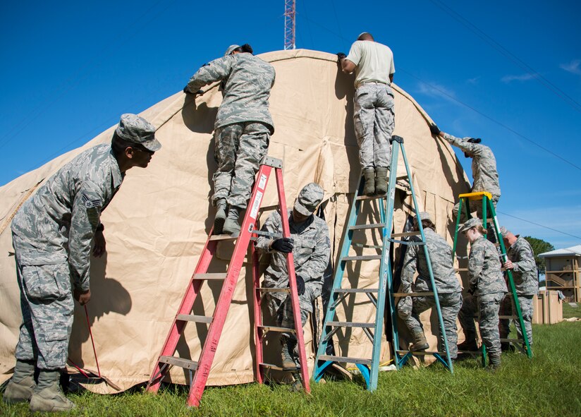 Members of the 919th Special Operations Force Support Squadron fasten the end of the canopy during small shelter system training at Duke Field, Fla., Sept. 13. The shelter takes six fully trained personnel approximately three and a half hours to complete. The SSS training is part of annual home station readiness training for all members of the squadron. (U.S. Air Force photo/ Tech. Sgt. Jasmin Taylor)  