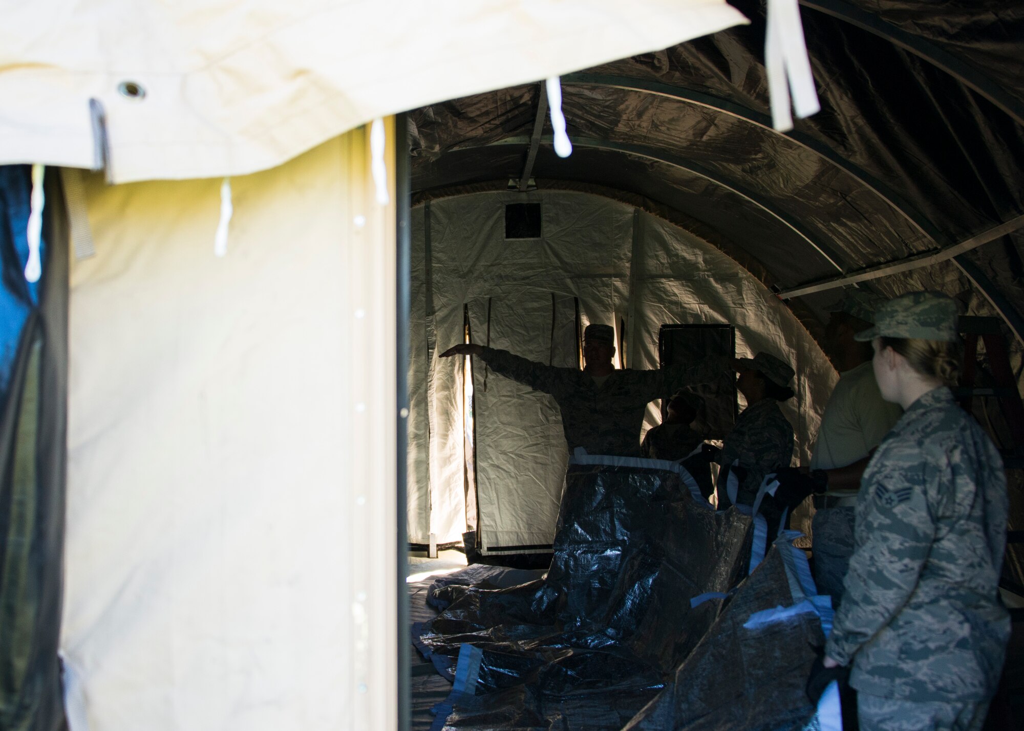 Members of the 919th Special Operations Force Support Squadron insert the lining on the inside of the shelter during small shelter system training at Duke Field, Fla., Sept. 13. The shelter takes six fully trained personnel approximately three and a half hours to complete. The SSS training is part of annual home station readiness training for all members of the squadron. (U.S. Air Force photo/ Tech. Sgt. Jasmin Taylor)  