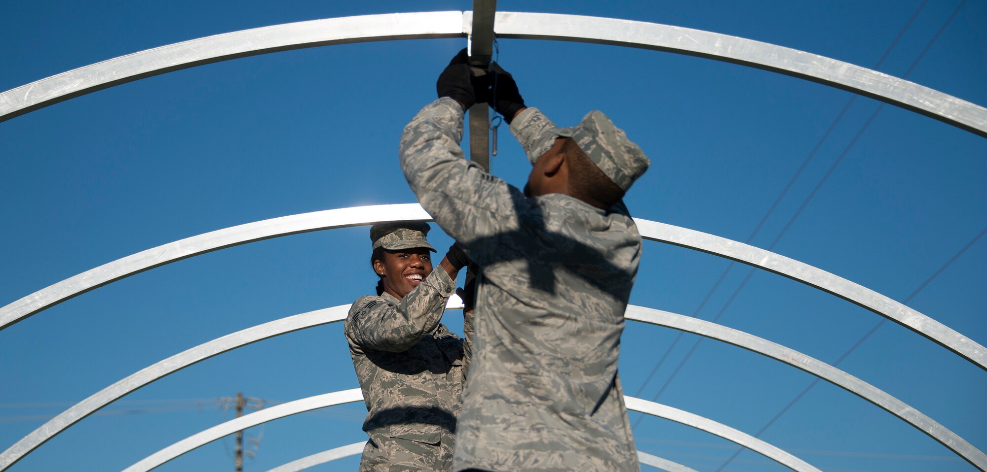 Senior Airman Charelle Baxter, 919th Special Operations Force Support Squadron, lifts a beam into place during small shelter system training at Duke Field, Fla., Sept. 13. The shelter takes six fully trained personnel approximately three and a half hours to complete. The SSS training is part of annual home station readiness training for all members of the squadron. (U.S. Air Force photo/ Tech. Sgt. Jasmin Taylor)  