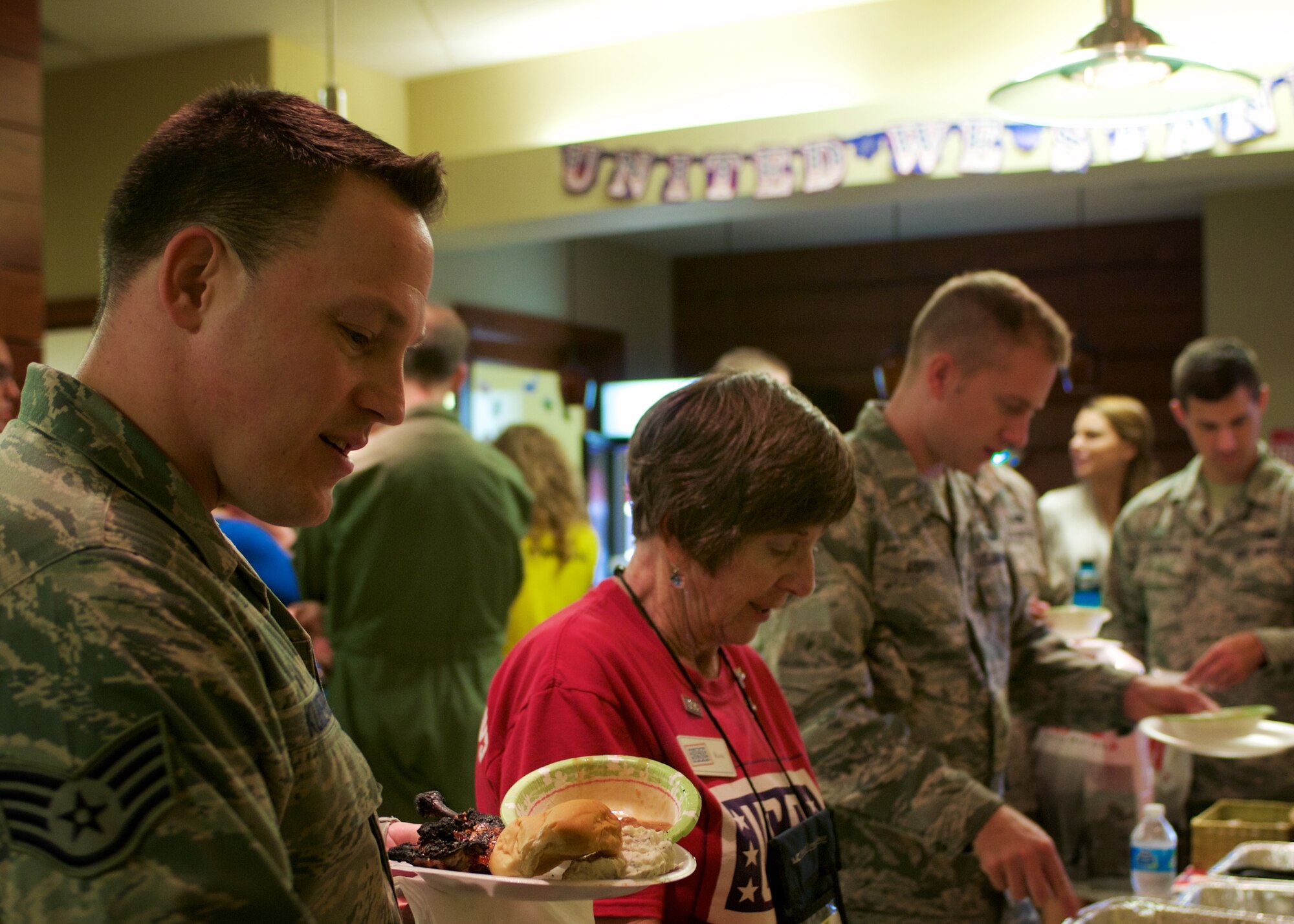 512th Airlift Wing Airmen and their families take a lunch break on to enjoy a free chicken barbeque event hosted by USO Delaware on Sept. 12, 2015 at Dover Air Force Base, Del. While gifts and takeaways were being handed out by the USO, members from the Second Brigade Motorcycle Club grilled for the hundreds of Reserve service members attending the event at the Dover Passenger Terminal. (U.S. Air Force photo/1st Lt. Steve Lewis)

