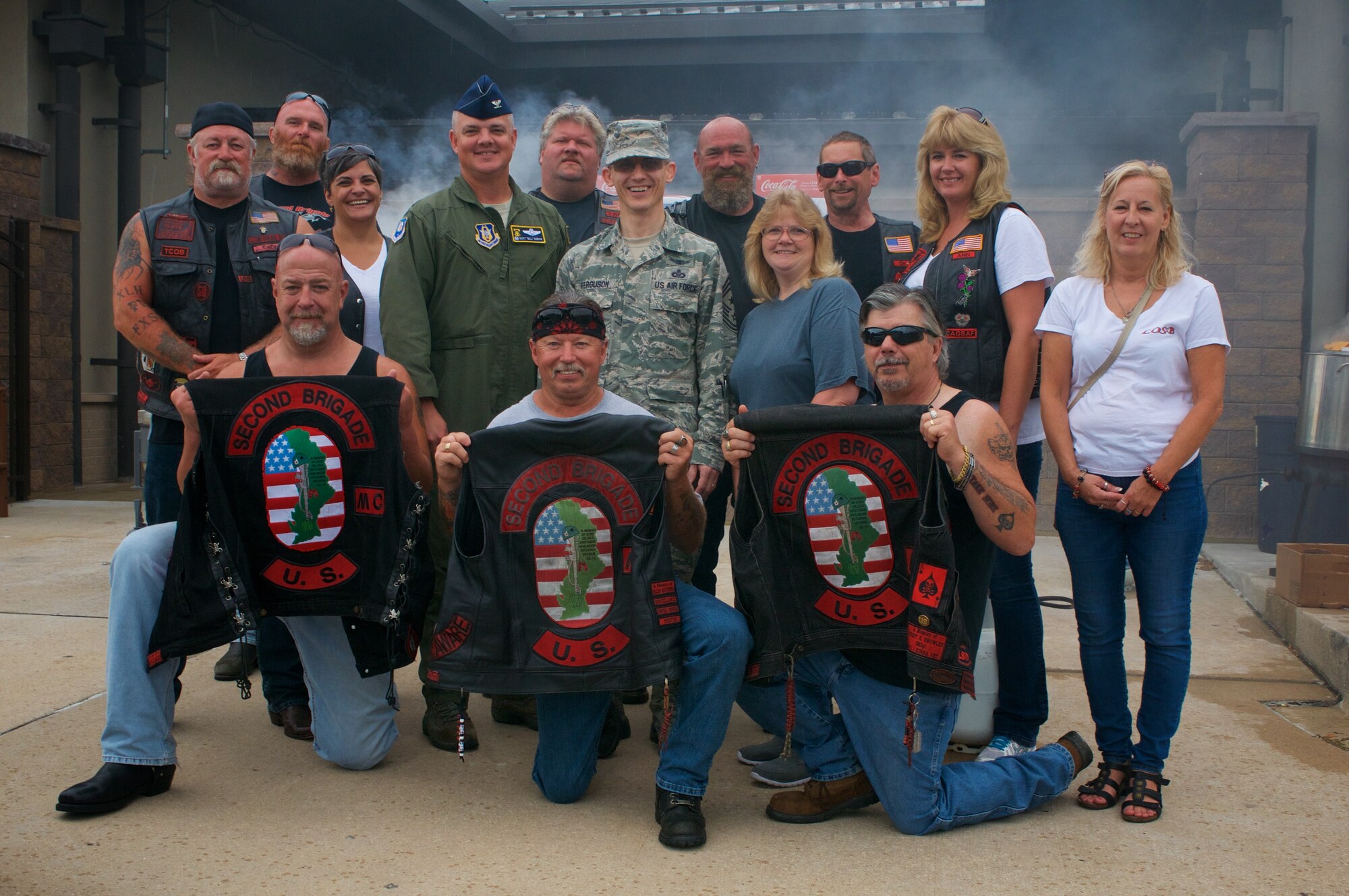 Col. D. Scott Durham, 512th Airlift Wing commander, and 512th AW Command Chief Master Sgt. Brad Ferguson, pose for a photo with members of the Second Brigade Motorcycle club during a USO Delaware 512th AW appreciation barbeque event on Sept. 12, 2015 at Dover Air Force Base, Del. The Second Brigade Motorcycle Club grilled for hundreds of Reserve Airmen and their families attending the event at the Dover Passenger Terminal. (U.S. Air Force photo/1st Lt. Steve Lewis)

