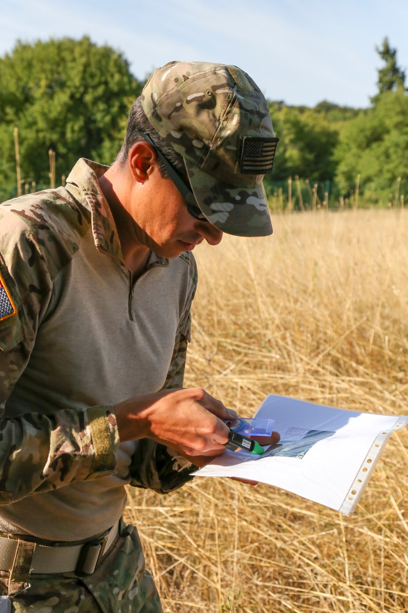 Maj. Peter Grossenbach, C-17 Globemaster III pilot with the 728th Airlift Squadron, plans the first leg of the orienteering competition during the Interallied Confederation of Reserve Officers, or CIOR, military competition in Shumen, Bulgaria, last month. After trying out and qualifying for Team USA Military, Grossenbach went on to represent the U.S. as part of an international team and won third place in the novice category. The pentathlon consists of: pistol shooting, rifle shooting, 500-meter land obstacle course, 50-meter water obstacle course, and up to a 15-kilometer orienteering, or land-navigation, event that also encompasses combat first aid. According to the CIOR Web site, the competition focuses on military skills that truly challenge the leadership and physical robustness of reservists. (Courtesy photo)