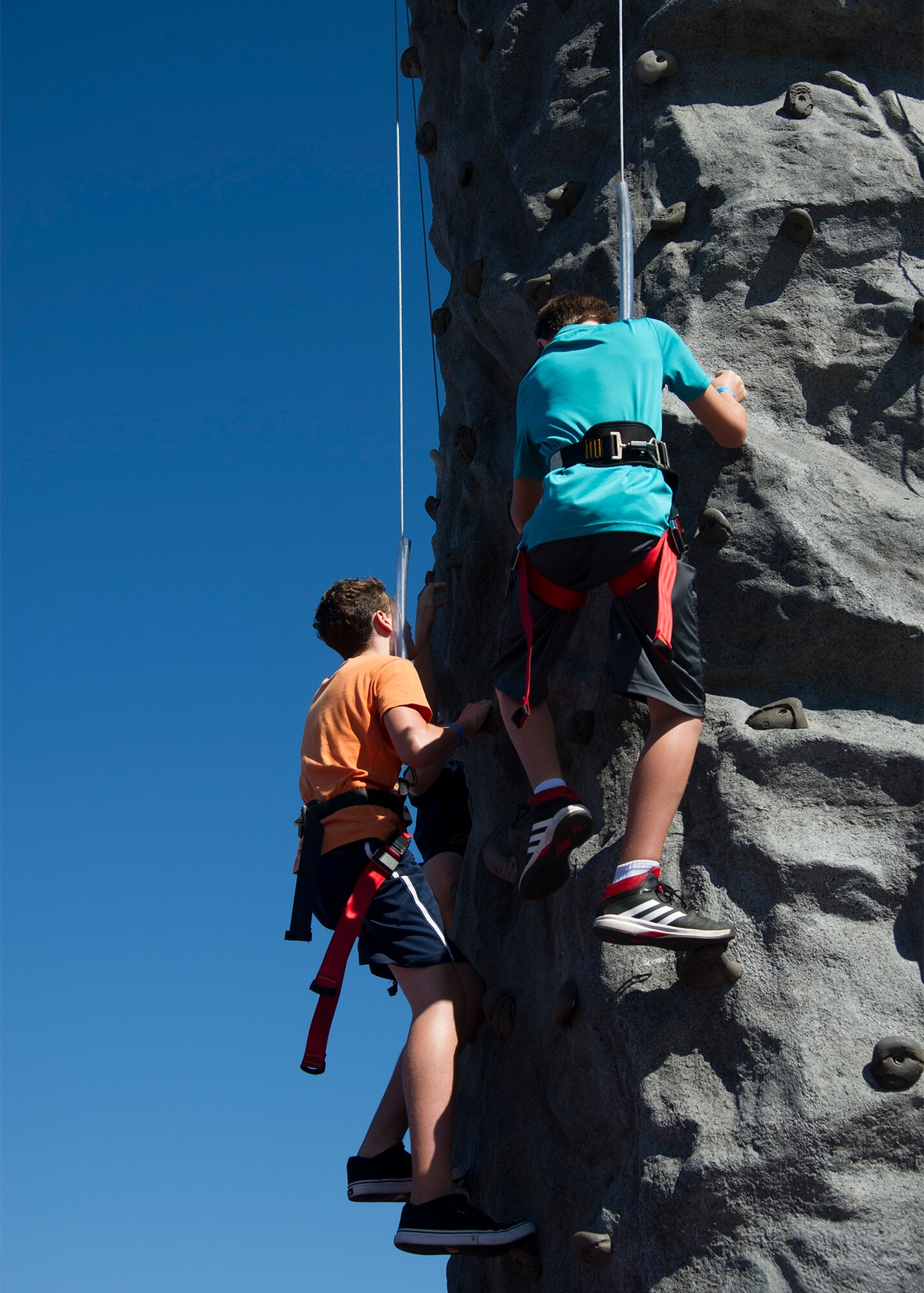 Son’s Luke (left) and Noah (right) of Master Sgt. Chris Caplan, of the 446th Aeromedical Evacuation Squadron, race up the rock climbing wall September 12, 2015, during the annual family day picnic at McChord Field. This year’s festivities included a spouse flight, barbeque and numerous games and activities for Reservists and families. (U.S. Air Force Reserve photo by Tech. Sgt. Bryan Hull/released) 