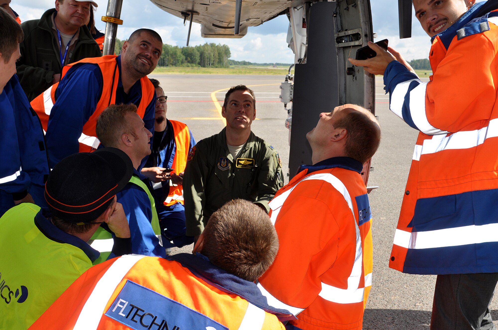 A-10 Thunderbolt II pilot, Lt. Col. Michael Leonas, 303d Fighter Squadron, 442d Fighter Wing out of Whiteman Air Force Base Mo., talks about the functions and capabilities of the A-10 to Kaunas International Airport employees Sept. 9. Leonas made history by landing the first A-10 in the country supporting Operation Atlantic Resolve. (U.S. Air Force photo by Capt. Denise Haeussler)