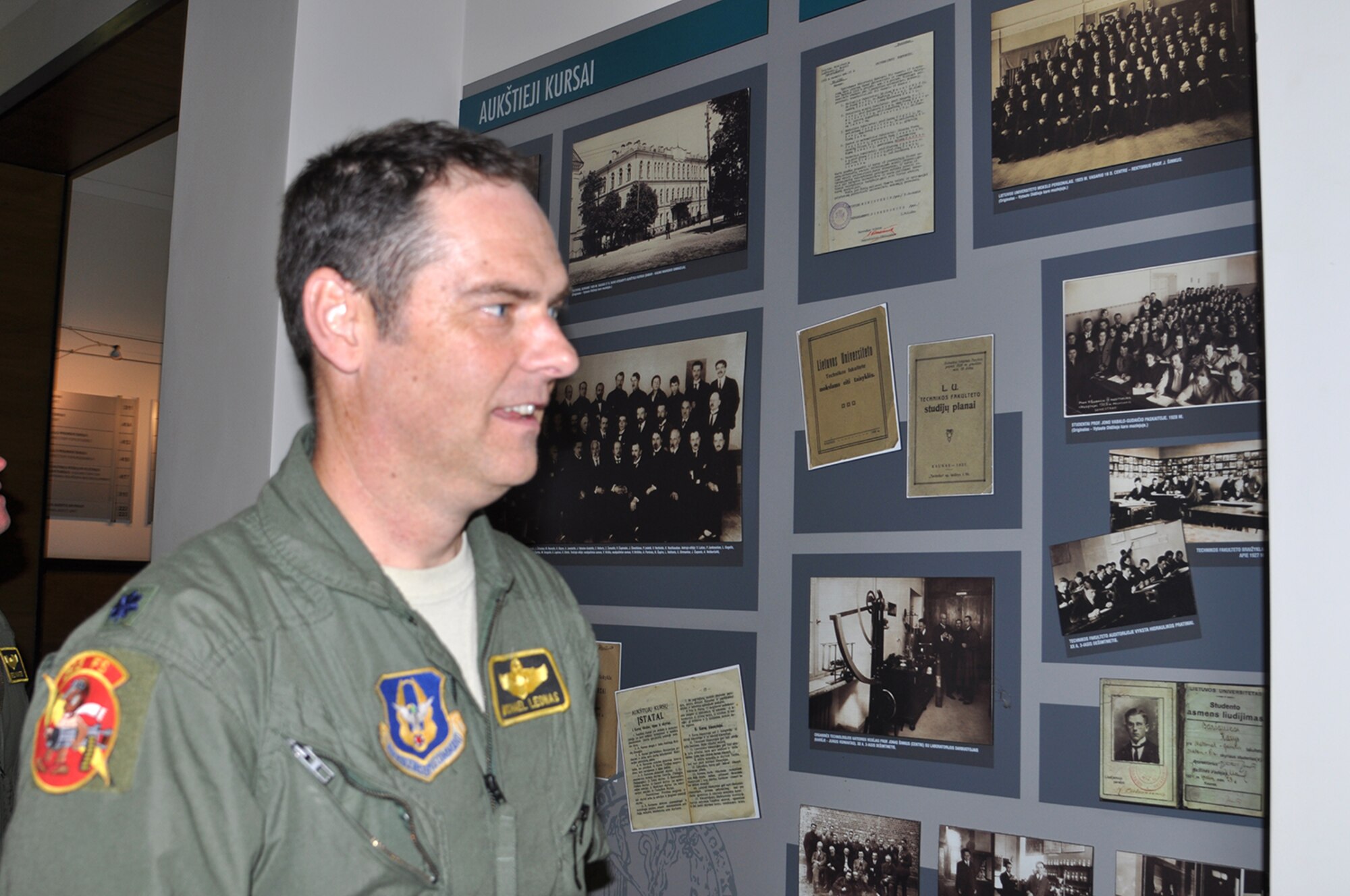 A-10 Thunderbolt II pilot, Lt. Col. Michael Leonas, 303d Fighter Squadron, looks at various photos of his great grandfather Petras Leonas at Vytautas Magnus University in Kaunas, Lithuania Sept. 9. Leonas flew an A-10 into Kaunas International Airport as part of Operation Atlantic Resolve.  Having family ties to Lithuania, Leonas took a tour of the city and visited places where his great grandfather lived and worked. (U.S. Air Force photo by Capt. Denise Haeussler)