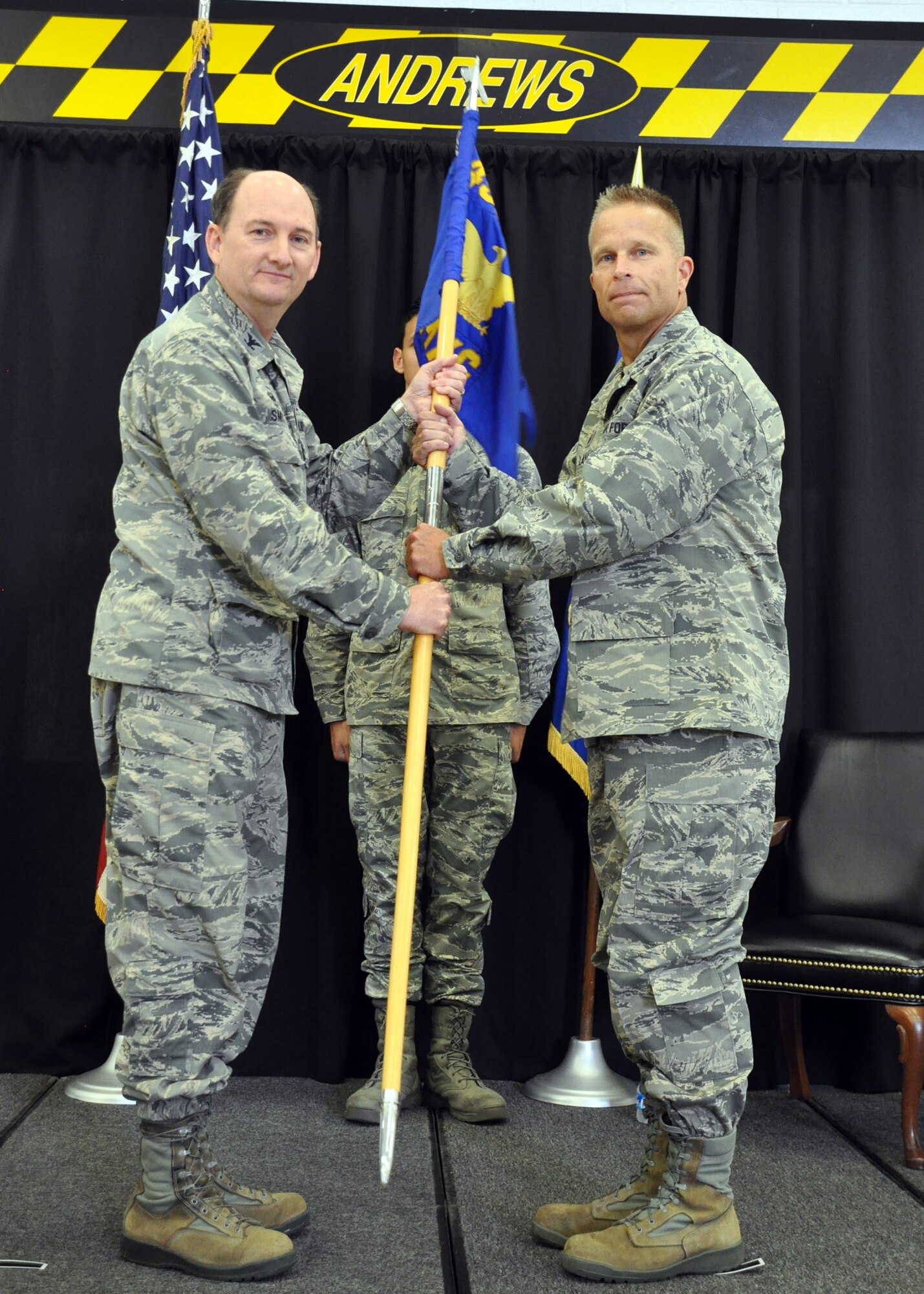 Col. Thomas K. Smith Jr., 459th Air Refueling Wing commander, Joint Base Andrews, Md., passes the guidon to Col. Roger S. Law, during the 459th Maintenance Group Assumption of Command ceremony held on September 12th, 2015. This will be Col. Law’s third maintenance commander position.  (U.S. Air Force photo / Senior Airman Kristin Kurtz)