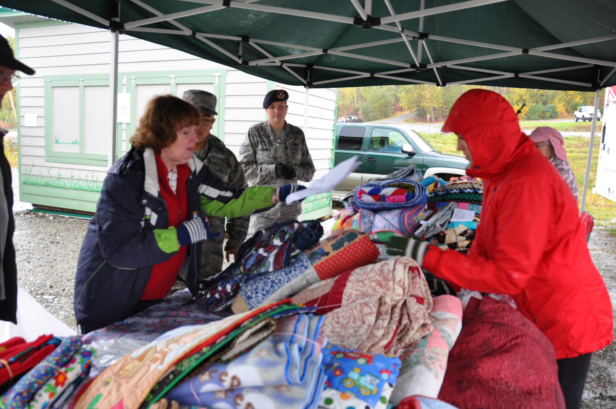 Staff Sgt. Soo Xiong and Tech. Sgt. Kelley Lasiewicz, Air Force Reservists assigned to the 477th Fighter Group, assist members of the Willow Recovery Team select blankets for families affected by the Sockeye fire. The Sockeye fire began in June and destroyed thousands of acres of land near Willow, Alaska to include destruction of 55 homes. (U.S. Air Force photos/Maj. Ashley Conner)
