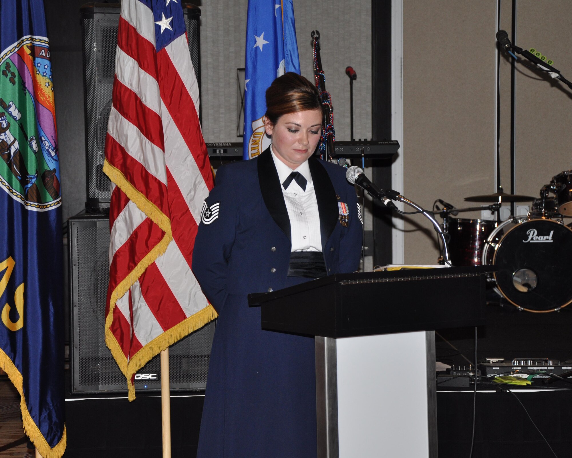 Tech. Sgt. Anne Phillips, 93st Maintenance Squadron jet engine mechanic, looks at her notes while acting as an emcee during the  Air Force Ball in Wichita, Kan., Sept. 12, 2015. The event was a celebration of the 68th birthday of the Air Force. Mike Pompeo was the guest of honor, and spoke about what it means to him to be a representative in Congress for the area. (U.S. Air Force photo by Tech. Sgt. Abigail Klein)