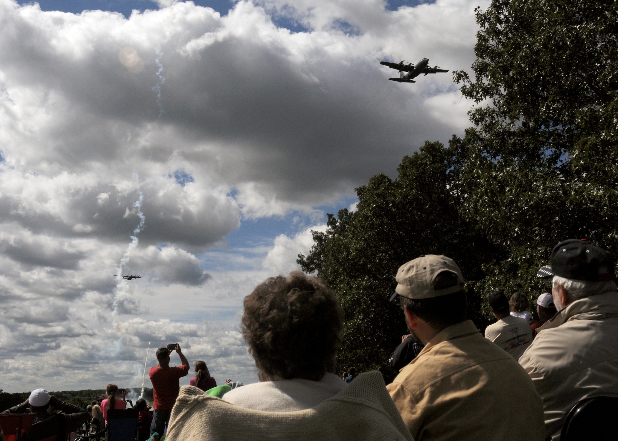 Central Missouri community members watch as C-130 aircraft of the 139th Airlift Wing fly over an outreach event hosted by the Missouri Air National Guard’s 131st Bomb Wing, Detachment 1 - Cannon Range, near Laquey, Missouri, Sept. 12, 2015.  More than 850 guests participated in the family-friendly event that included munitions demonstrations by the B-2 Spirit stealth bomber, A-10 Thunderbolt II attack aircraft, and C-130 Hercules transport. (U.S. Air National Guard photo by Senior Airman Nathan Dampf)

