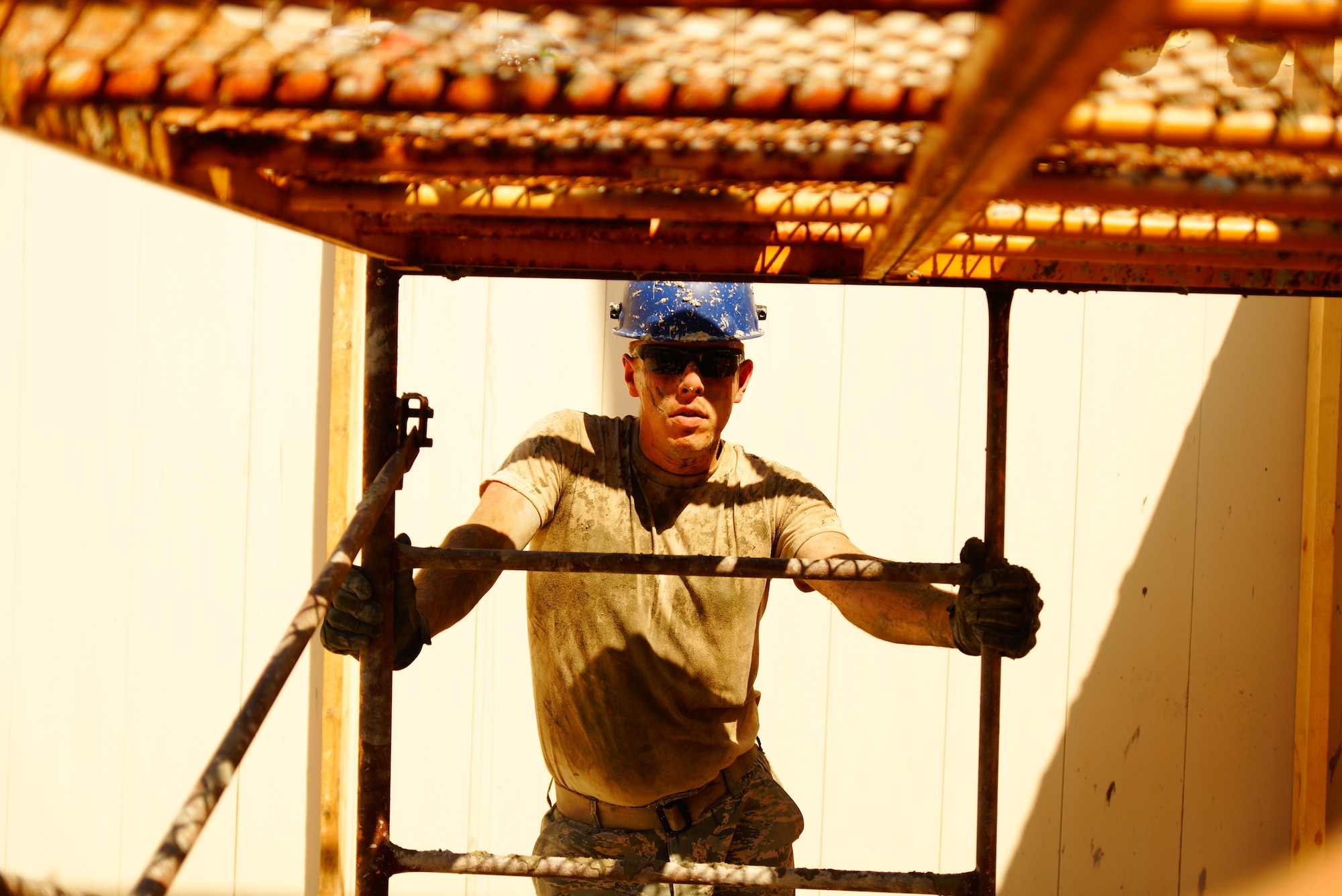 Staff Sgt. Daniel Plourde with the HVAC section prepares to move scaffold for the crews pouring cement overhead July 23, 2015, at Hatzor Air Base, Israel, in support of Operation JUNIPER COBRA . (U.S. Air National Guard photos by Master Sgt. Robert Armstrong)