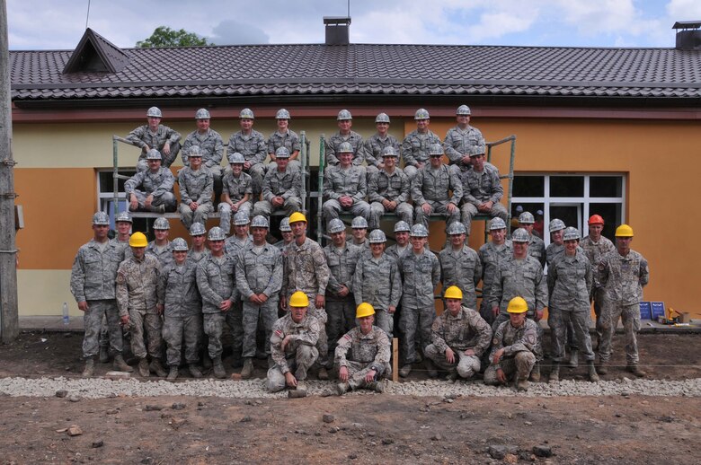 Members of the 171st Air Refueling Wing Engineer Squadron team pose with soldiers from the Latvian Army at the Naujene Orphanage in Latvia. Both groups have been remodeling a building st the orphanage as part of a Humanitarian Civic Assistance project. (Photo Courtesy of Kristina Isate, Latvian Embassy)