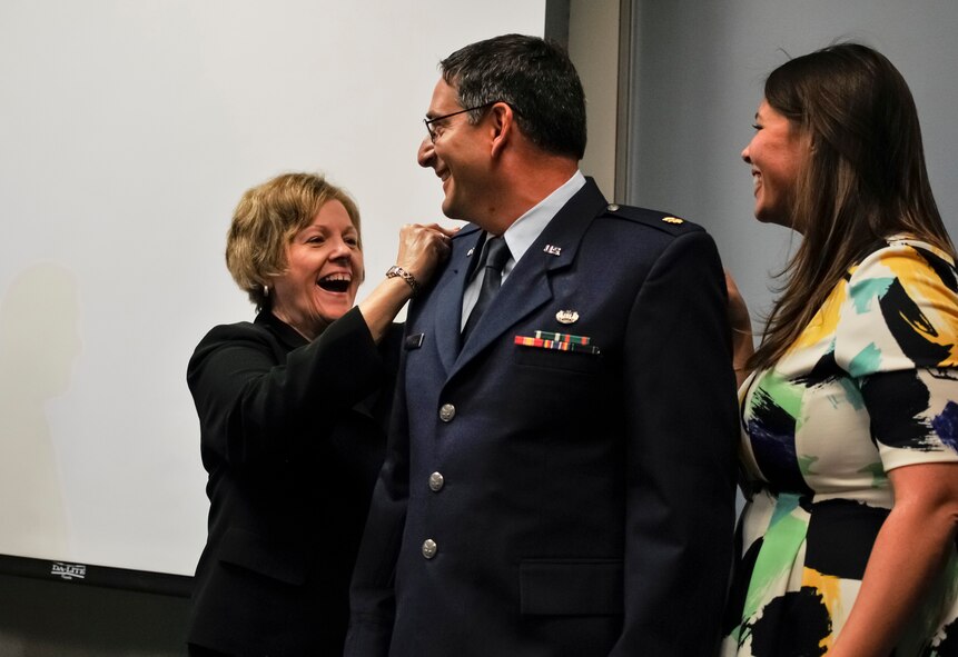 U.S. Air Force Maj. Charles G. Schierer, deputy staff judge advocate at the 182nd Airlift Wing, Illinois Air National Guard, has the rank of major pinned on by his family after being promoted in Peoria, Ill., Sept. 12, 2015. As part of the Judge Advocate General Corps, Schierer provides professional counsel and a full spectrum of legal capabilities to the Airmen in his unit. (U.S. Air National Guard photo by Staff Sgt. Lealan Buehrer/Released)