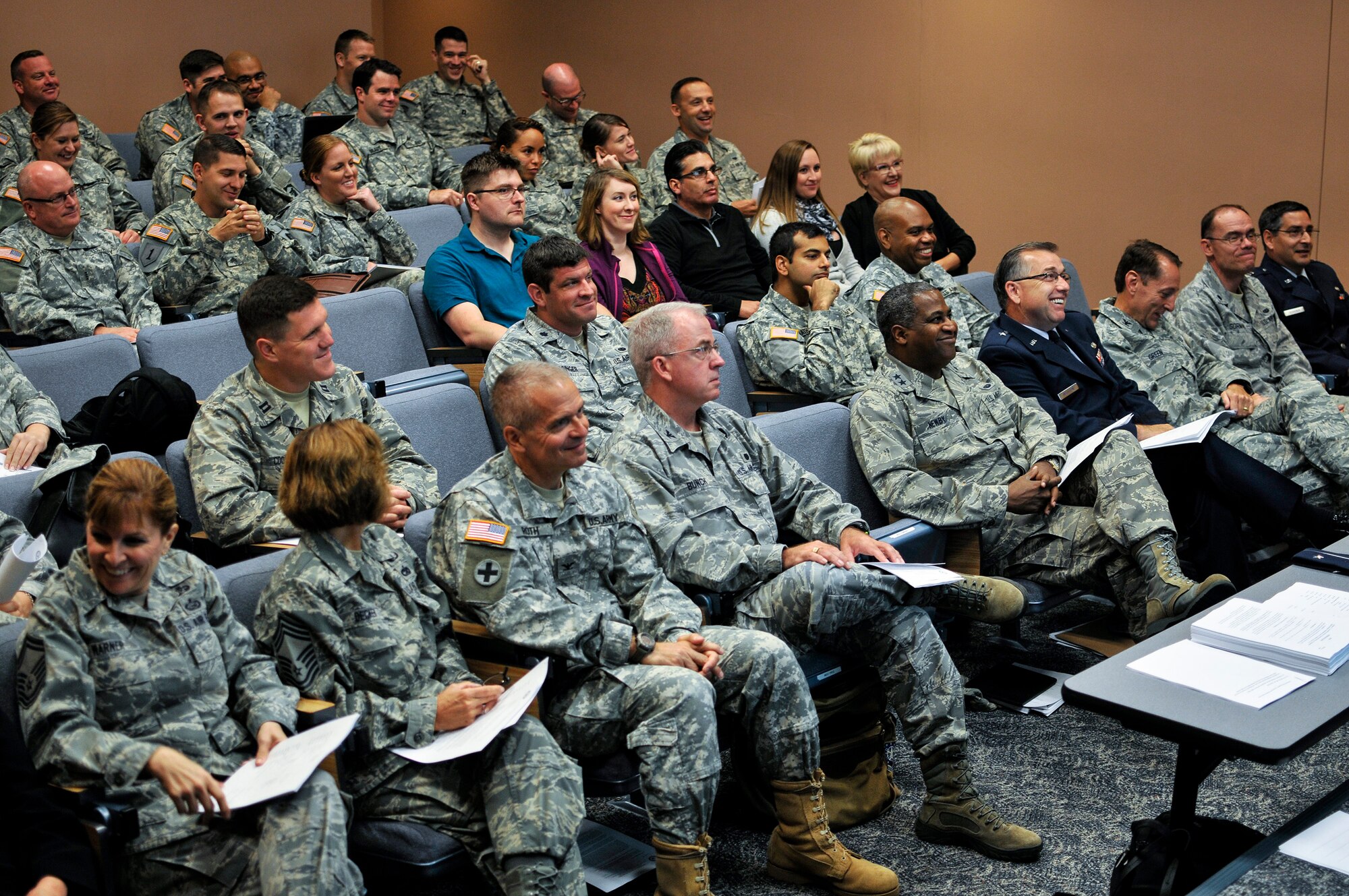 Soldiers and Airmen with the Judge Advocate General Corps watch a welcome briefing during a joint-force training workshop held at the 182nd Airlift Wing, Peoria, Ill., Sept. 12, 2015. The JAG Corps provides professional counsel and a full spectrum of legal capabilities to service members. (U.S. Air National Guard photo by Staff Sgt. Lealan Buehrer/Released)