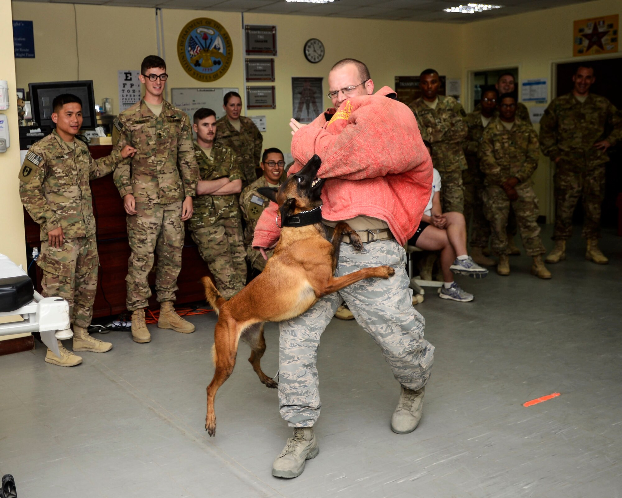 U.S. Air Force Staff Sgt. Kurtis Buchawiecki, 386th Expeditionary Security Forces Squadron Military Working Dog handler, does a MWD demonstration with GGreta, 386 ESFS MWD, after  emergency medical training at an undisclosed location in Southwest Asia, Sept. 12, 2015. Buchawiecki demonstrated and talked about some of the capabilities MWDs help in the fight against the Islamic State or ISIL. (U.S. Air Force photo by Senior Airman Racheal E. Watson/Released)