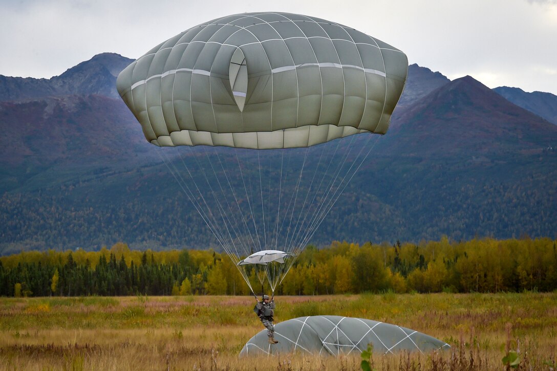 A paratrooper prepares to land while conducting an airborne operation over Malemute drop zone on Joint Base Elmendorf-Richardson, Alaska, Sept. 10, 2015. U.S. Air Force photo by Justin Connaher