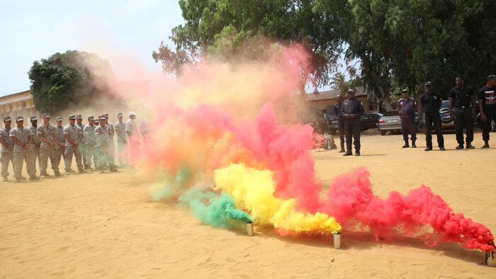 Benin National Surveillance Police commemorated the Sept. 11, 2001, anniversary attacks with U.S. Marines and sailors at the National Police Academy in Cotonou, Benin, today. The Marines and sailors with Special-Purpose Marine Air-Ground Task Force Crisis Response-Africa are in Benin for a month-long training mission with the National Surveillance Police to help counter  illicit trafficking along the country’s borders. During a break in the training, NPS students stood alongside Marines and sailors in formation for a brief ceremony to remember the day when more than 3,000 lives perished from the heinous terrorist attack. The ceremony began with the playing of taps, followed by three smoke cans, releasing colors of the Benin flag, symbolizing the partnership between the U.S. and Benin.