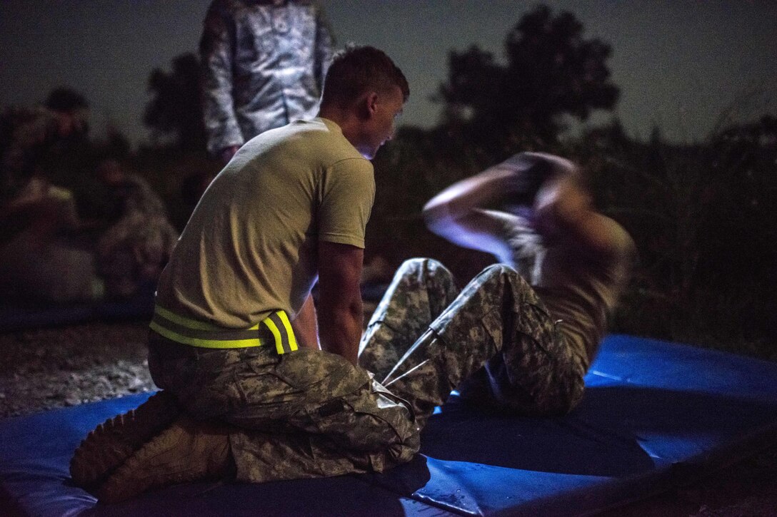 Army Reserve and National Guard combat engineer competitors perform situps during the Sapper Stakes 2015 Army Physical Fitness Test on Fort Chaffee, Ark., Aug. 31, 2015. U.S. Army photo by Master Sgt. Michel Sauret