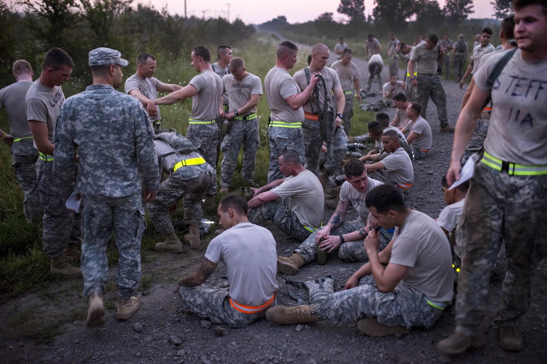 Army Reserve and National Guard combat engineers take a breather and stretch after the Sapper Stakes 2015 Army Physical Fitness Test on Fort Chaffee, Ark., Aug. 31, 2015. U.S. Army photo by Master Sgt. Michel Sauret