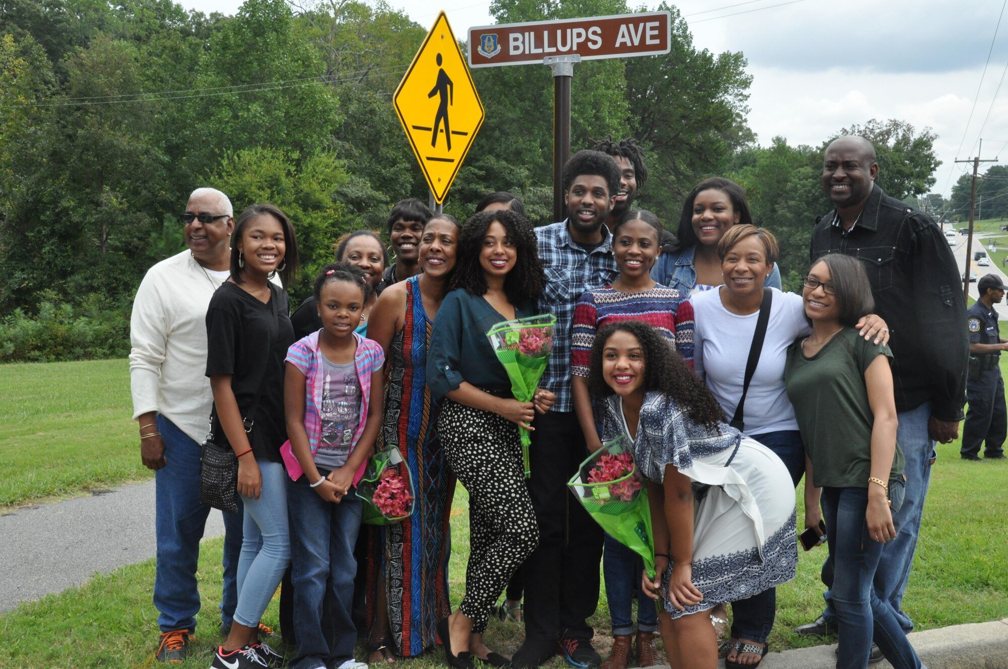 Members of Lt. Col. Aundra Billups’ family pose with the new Billups Avenue sign at Dobbins Air Reserve Base, Ga. Sep. 12, 2015. Billups, a former Dobbins pilot, passed away Sep. 11, 2013, was honored by receiving a road dedication in his name. (U.S. Air Force photo/ Senior Airman Miles Wilson)