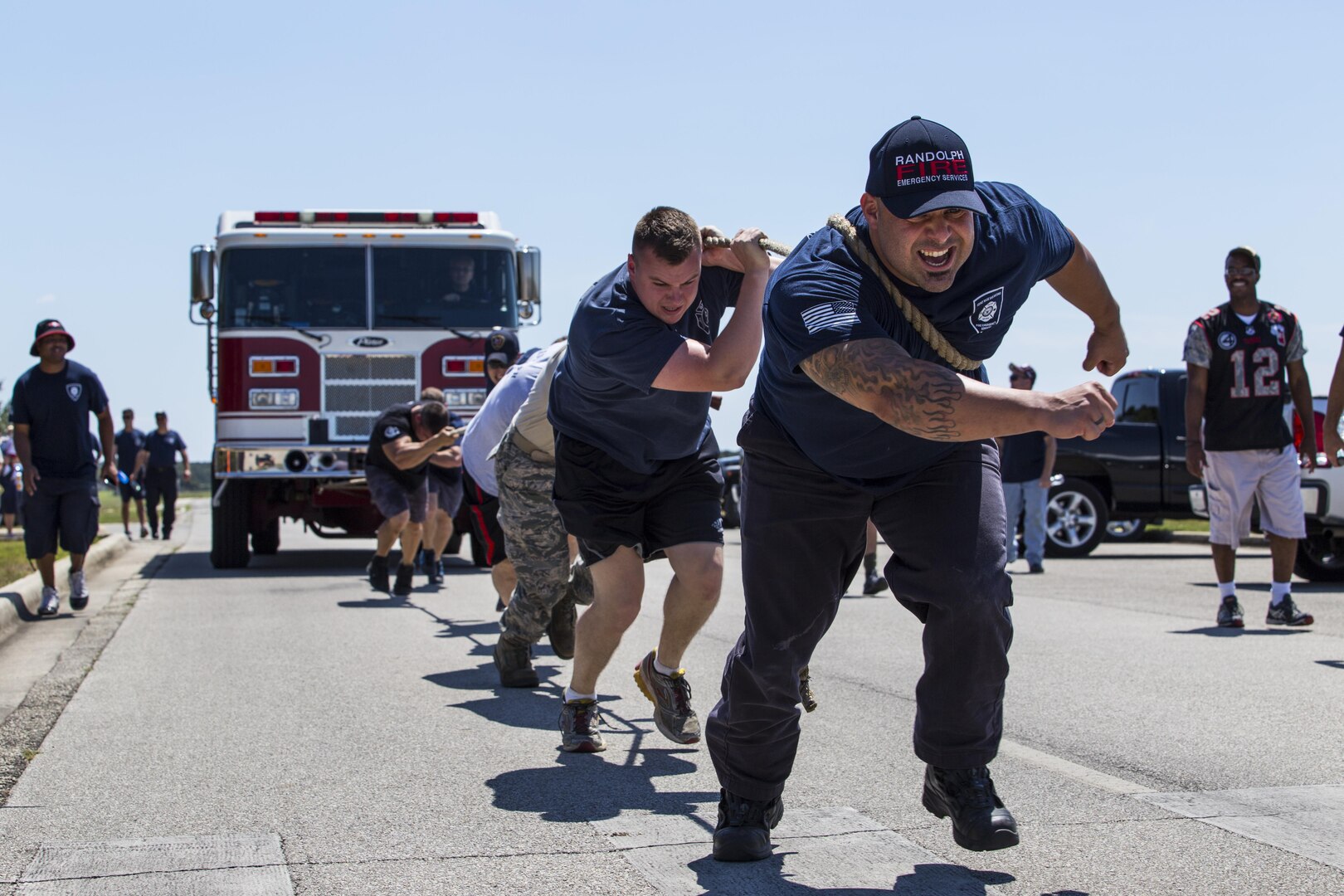 Michael Coscrelli, 502nd Civil Engineer Squadron firefighter, and 502nd CES firefighters pull a fire truck Sept. 12 during the final challenge of the 2015 Battle of the Badges at Joint Base San Antonio-Randolph. Battle of the Badges takes place each year to build camaraderie, espirit de corps and cohesion among JBSA first responders through various competitive challenges taken from their daily missions. The firefighters won all three main challenges for time, taking back the trophy from last year’s security forces’ victory and becoming the 2015 Battle of the Badges champions.