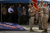 U.S. Marine Corps Sgt. Maj. William T. Sowers, 1st Marine Division Sergeant Major, presents the battle colors to Brig. Gen. Daniel D. Yoo, 1st Marine Division Commanding General, during a change of command ceremony at Marine Corps Base Camp Pendleton, Calif., Sept. 10, 2015. The ceremony signifies the transfer of responsibility and authority of 1st Marine Division between Commanding Generals. (U.S. Marine Corps photo by Pfc. Nathaniel Castillo, 1st Marine Division Combat Camera/Released)