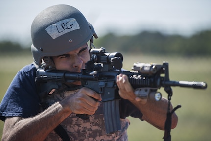 Airman Evan Nares, 502nd Civil Engineer Squadron firefighter, fires an M-4 carbine during the tactical shooting portion of the JBSA Battle of the Badges Sept. 12, 2015, at JBSA-Randolph. Battle of the Badges takes place each year to build camaraderie, espirit de corps and cohesion among JBSA first responders through various competitive challenges taken from their daily missions.